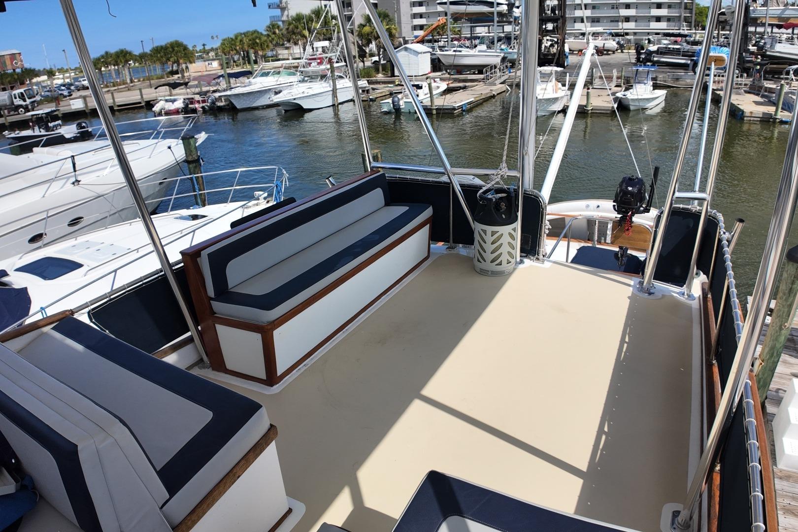 1978 Grand Banks 42 Classic yacht deck with seating, docked at a marina.