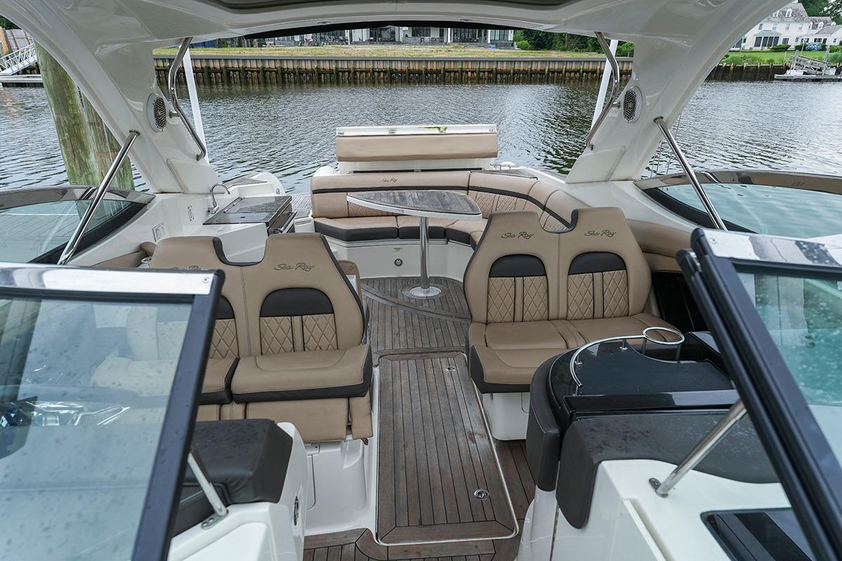 Luxurious interior of 2018 Sea Ray SLX 350 boat with elegant seating and table.
