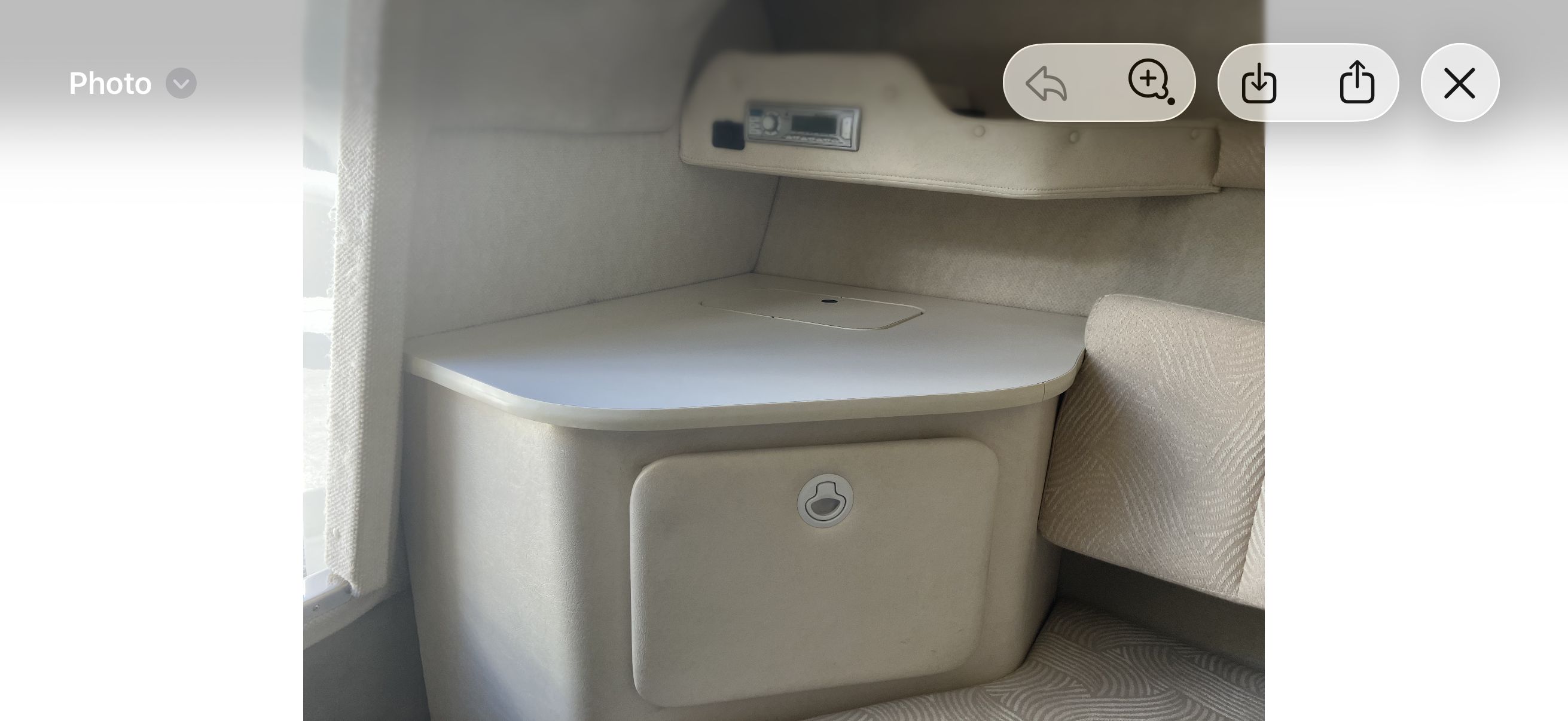 Interior of 2007 Sea Ray 215 Weekender with storage compartment.