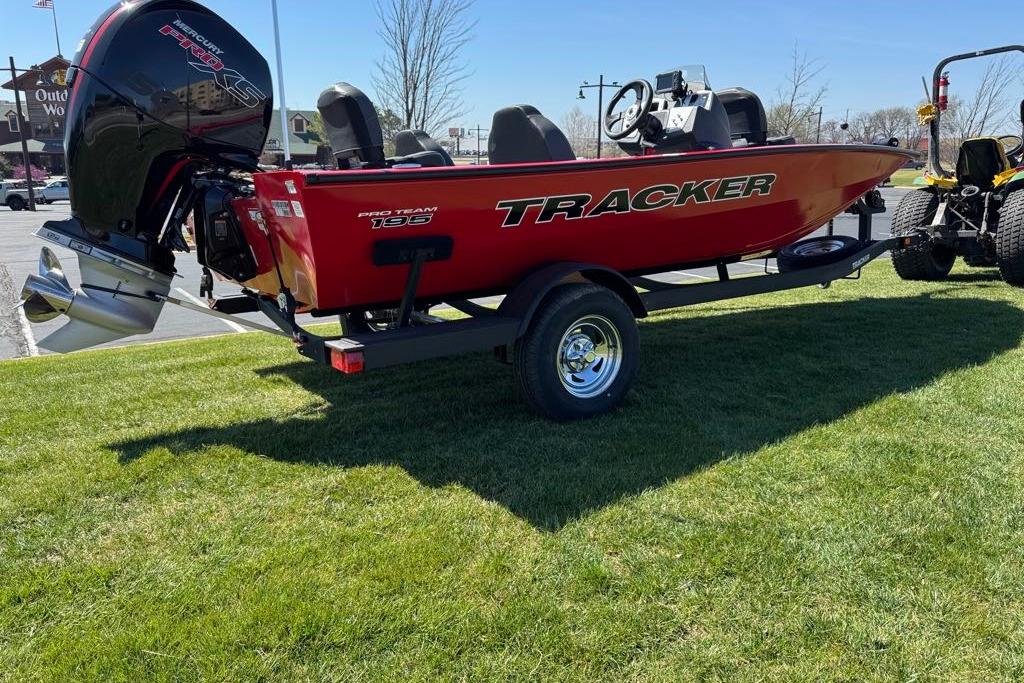 2026 Tracker Pro Team 195 boat on trailer, parked on grass.