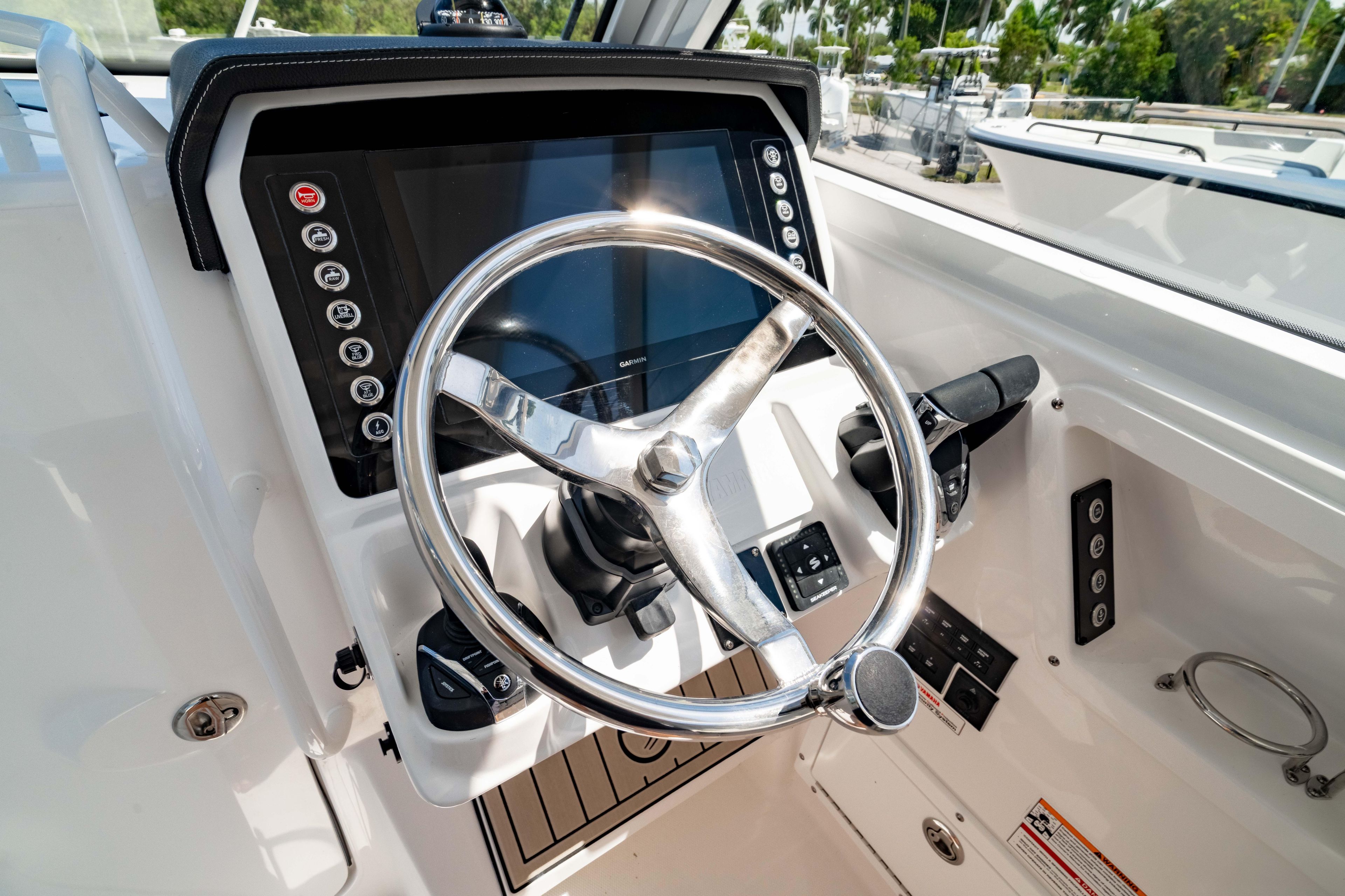2026 Edgewater 262CX Crossover boat helm with modern steering wheel and control panel.