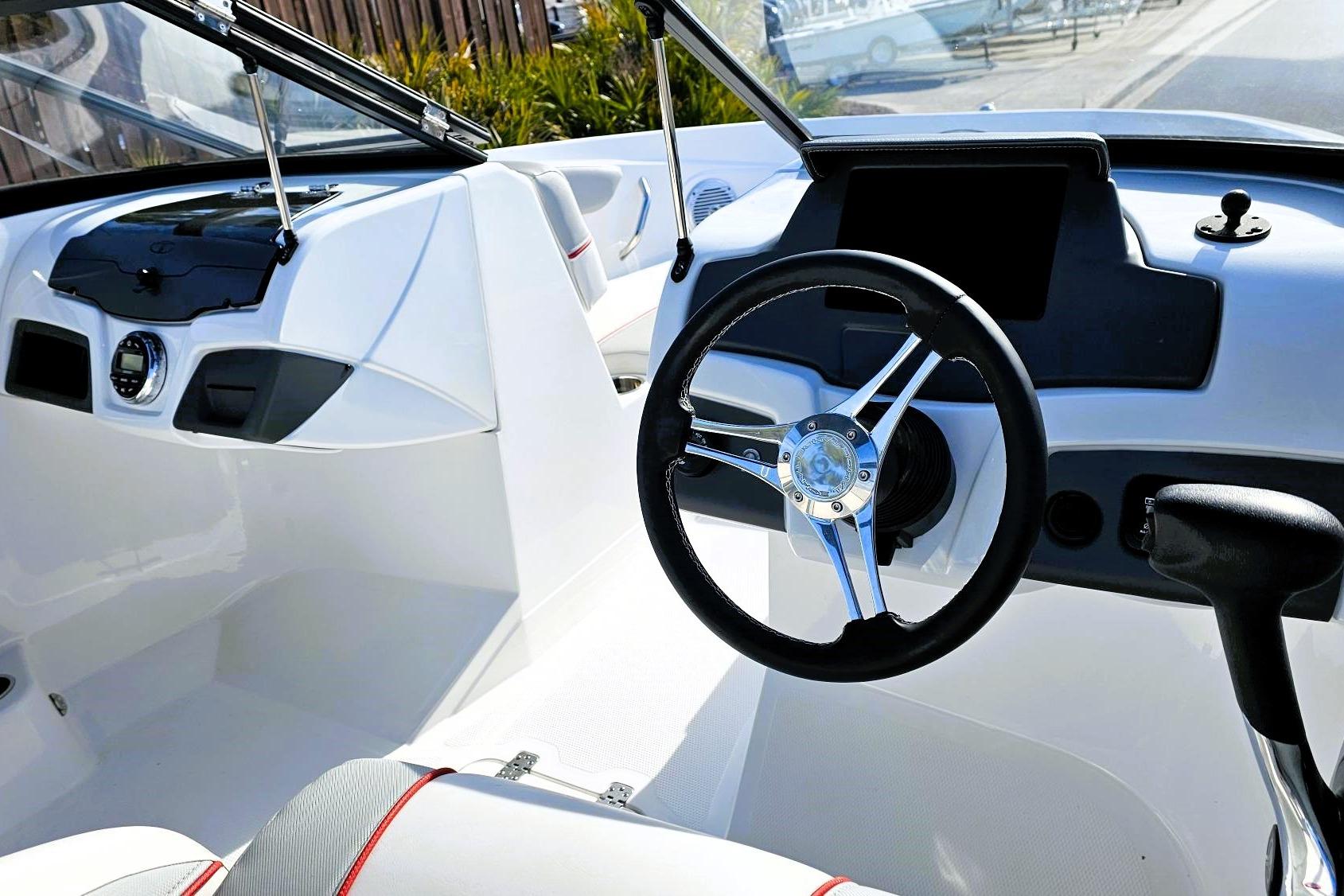 2023 Tahoe 210 Si boat interior with steering wheel and dashboard.