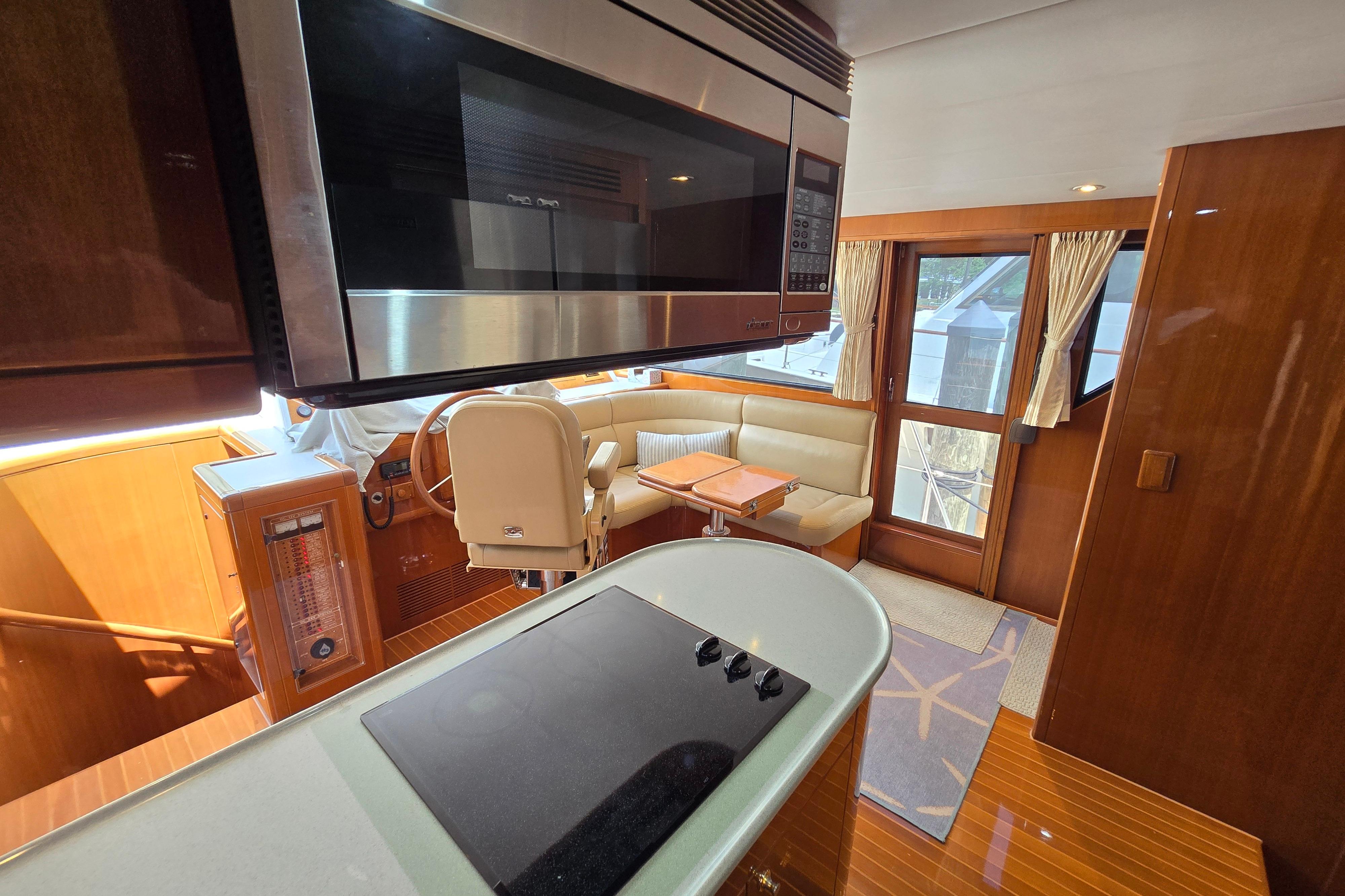Luxurious interior of 2004 Grand Harbour 58 yacht with modern kitchen and seating area.