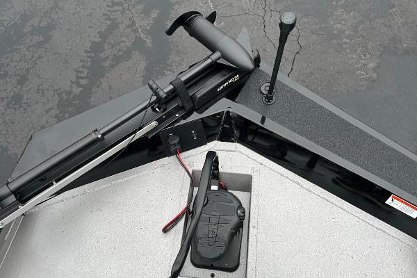 2024 Lowe Legacy boat with trolling motor and foot pedal on calm water.