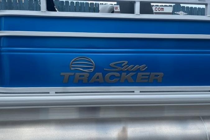 2026 Sun Tracker Fishin' Barge 20 DLX, blue exterior with logo detail.