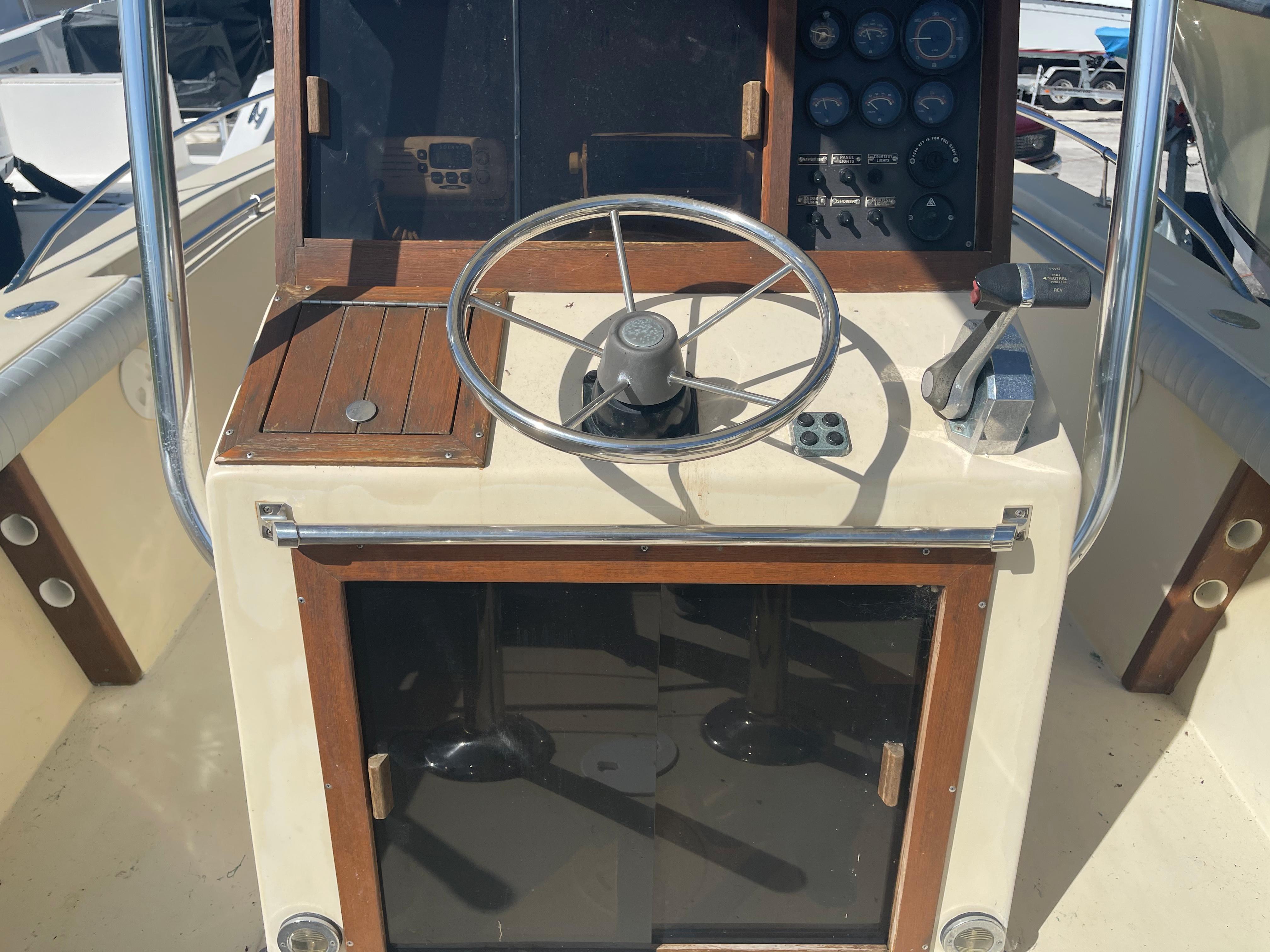 1986 Gulf Stream Yachts custom boat helm with steering wheel and control panel.