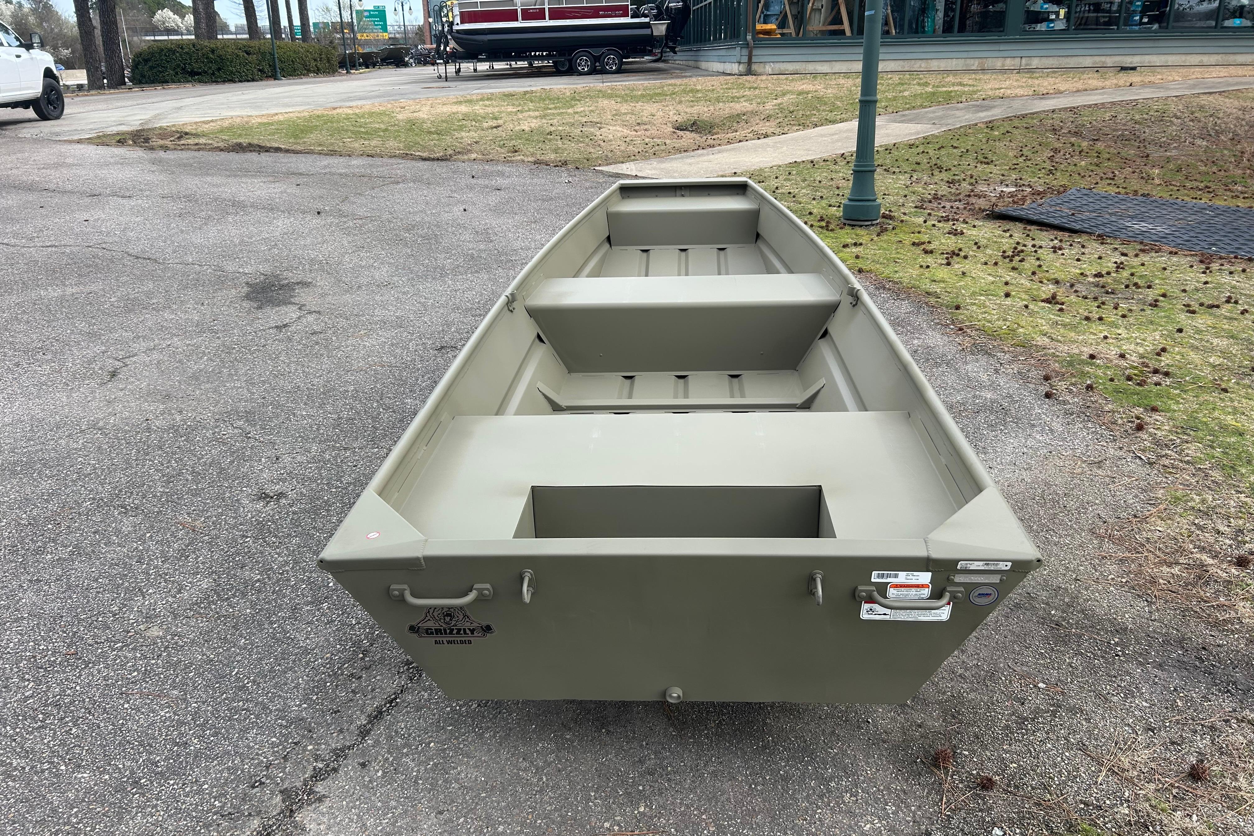 2026 Tracker Grizzly 14 Jon boat on pavement, showcasing its sturdy design and spacious interior.