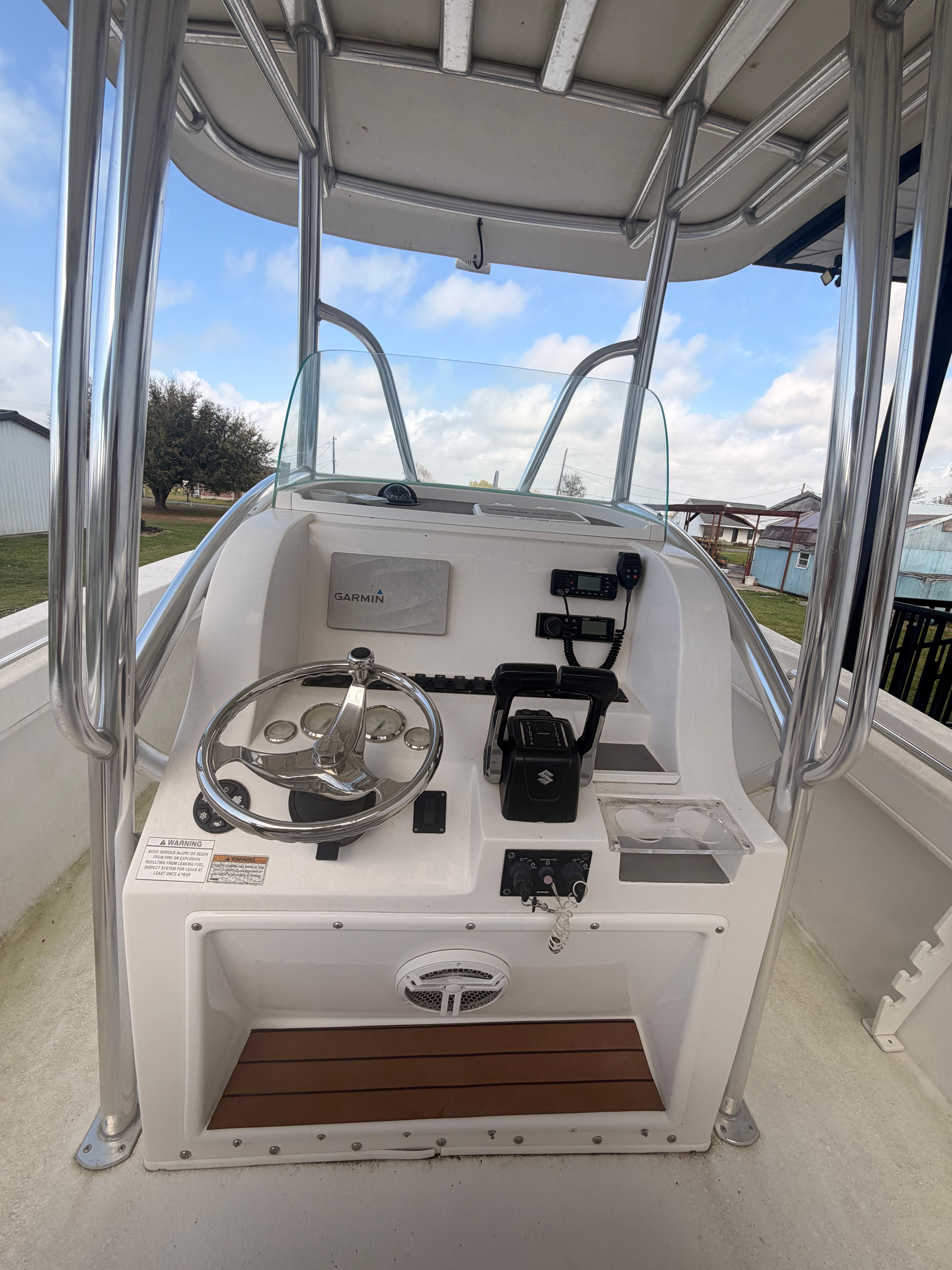 The image shows the helm of a Twin Vee Ocean Cat boat with modern equipment.