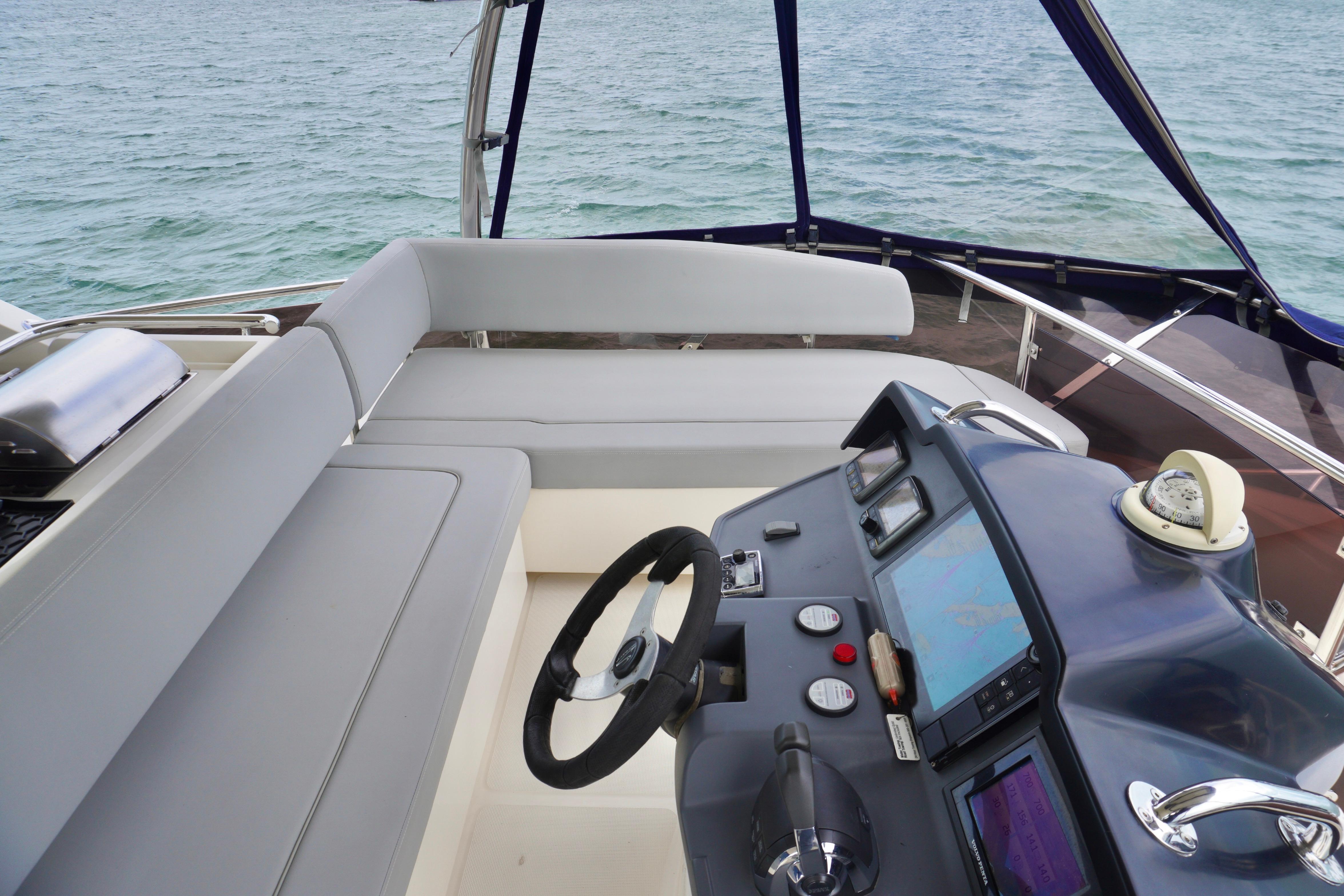 2017 Aquila 44 Yacht helm with navigation controls and seating, overlooking the ocean.