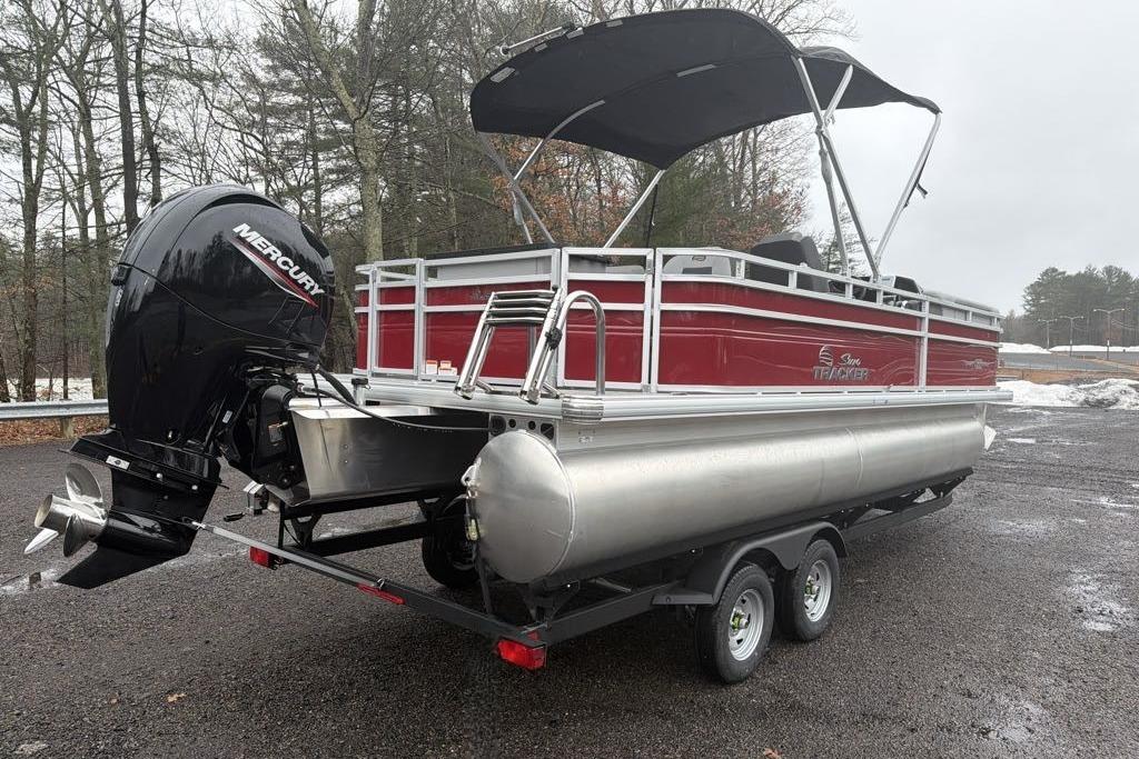 2026 Sun Tracker SportFish 22 DLX pontoon boat with Mercury outboard motor on trailer.