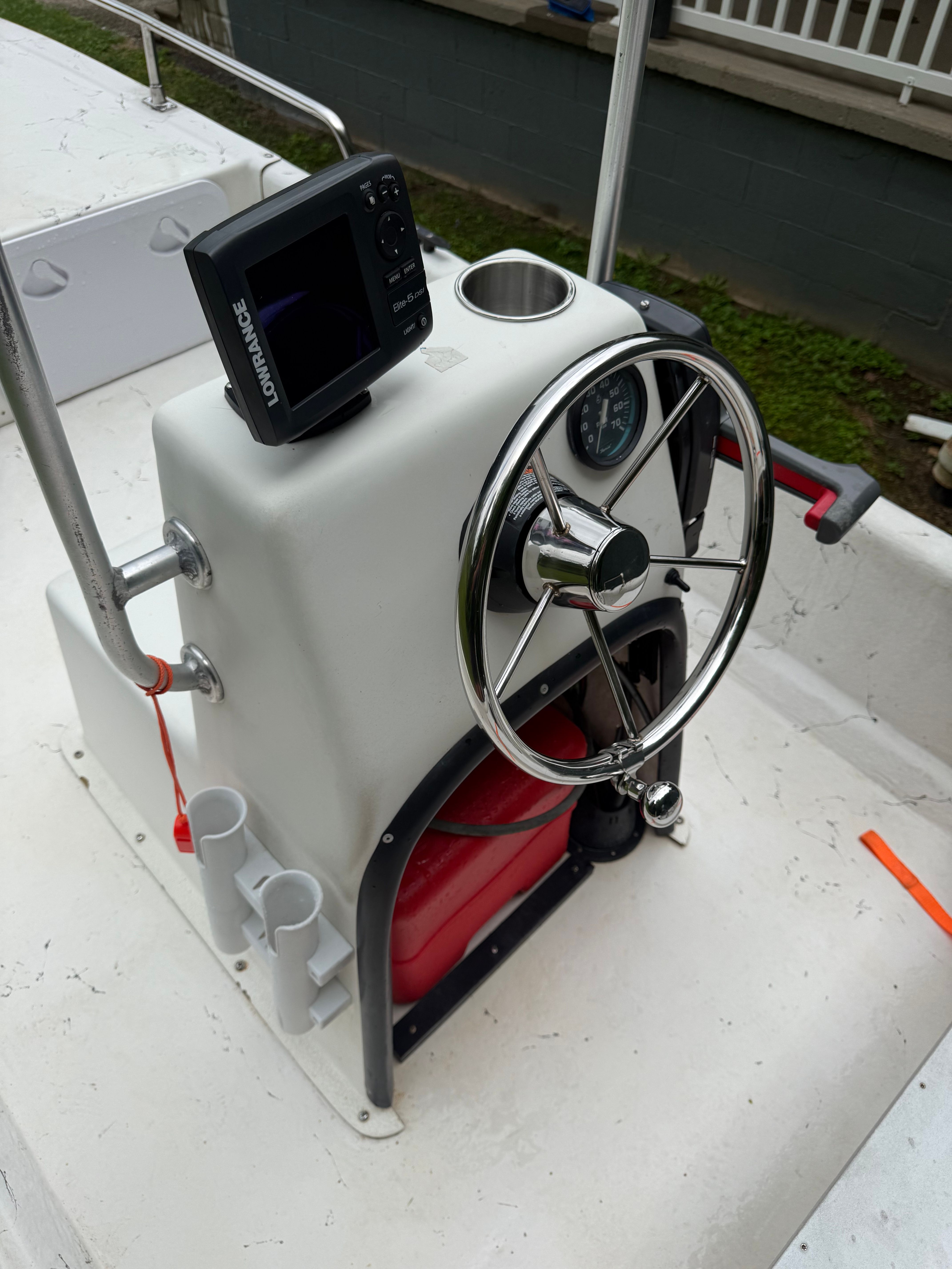 Helm of a 2009 Carolina Skiff J16CC with steering wheel and electronics.