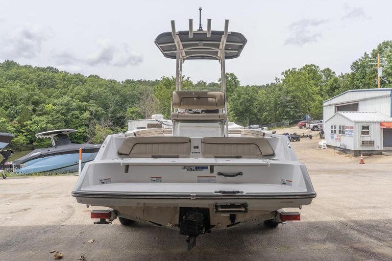 2023 Yamaha Boats 195 FSH Sport, rear view at a marina with trees and buildings.