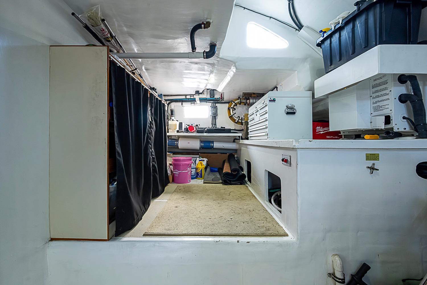 Engine room of 2014 Marlow 80 Explorer yacht with tools and storage.