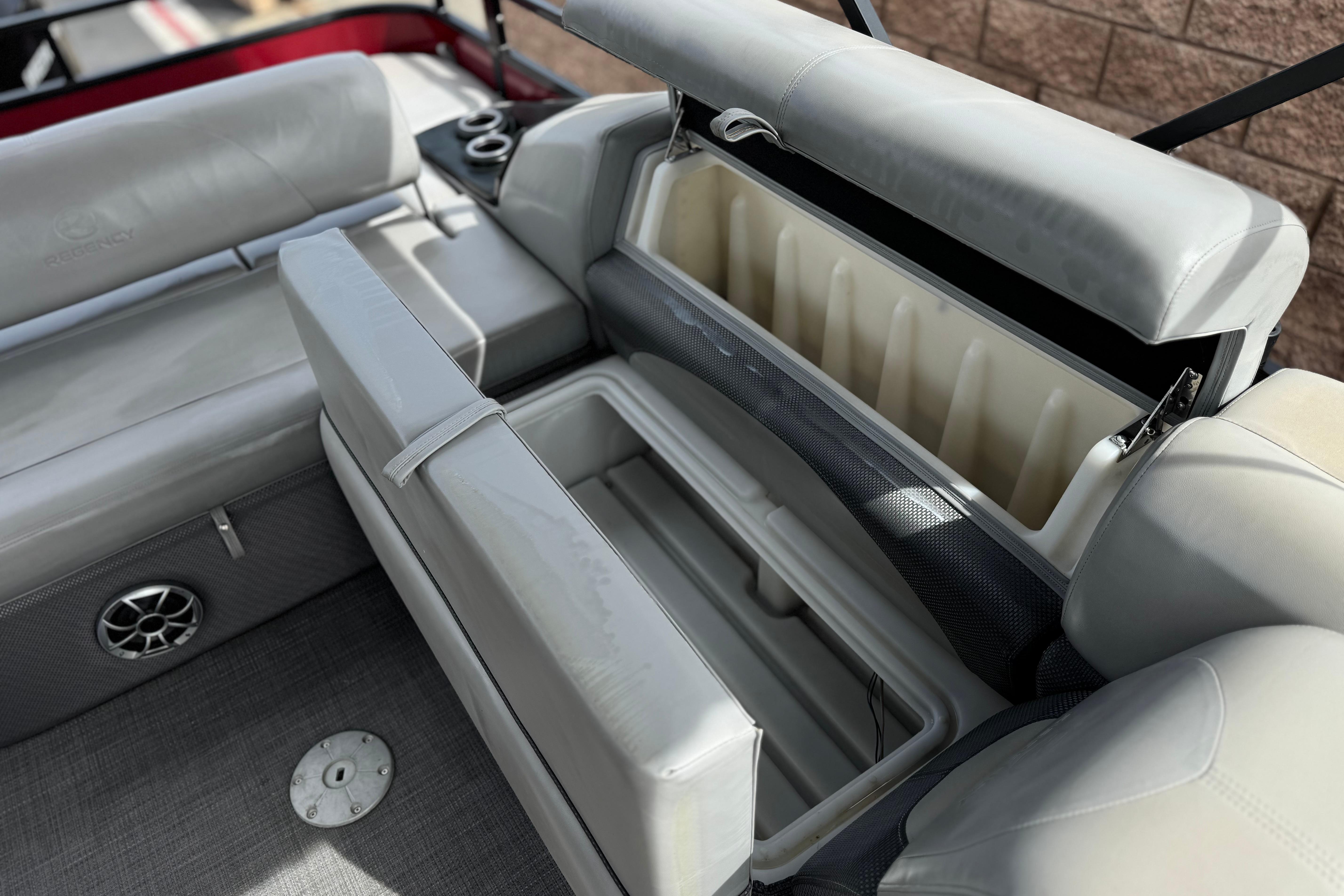 2022 Regency 250 DL3 boat interior with open storage compartment and seating.