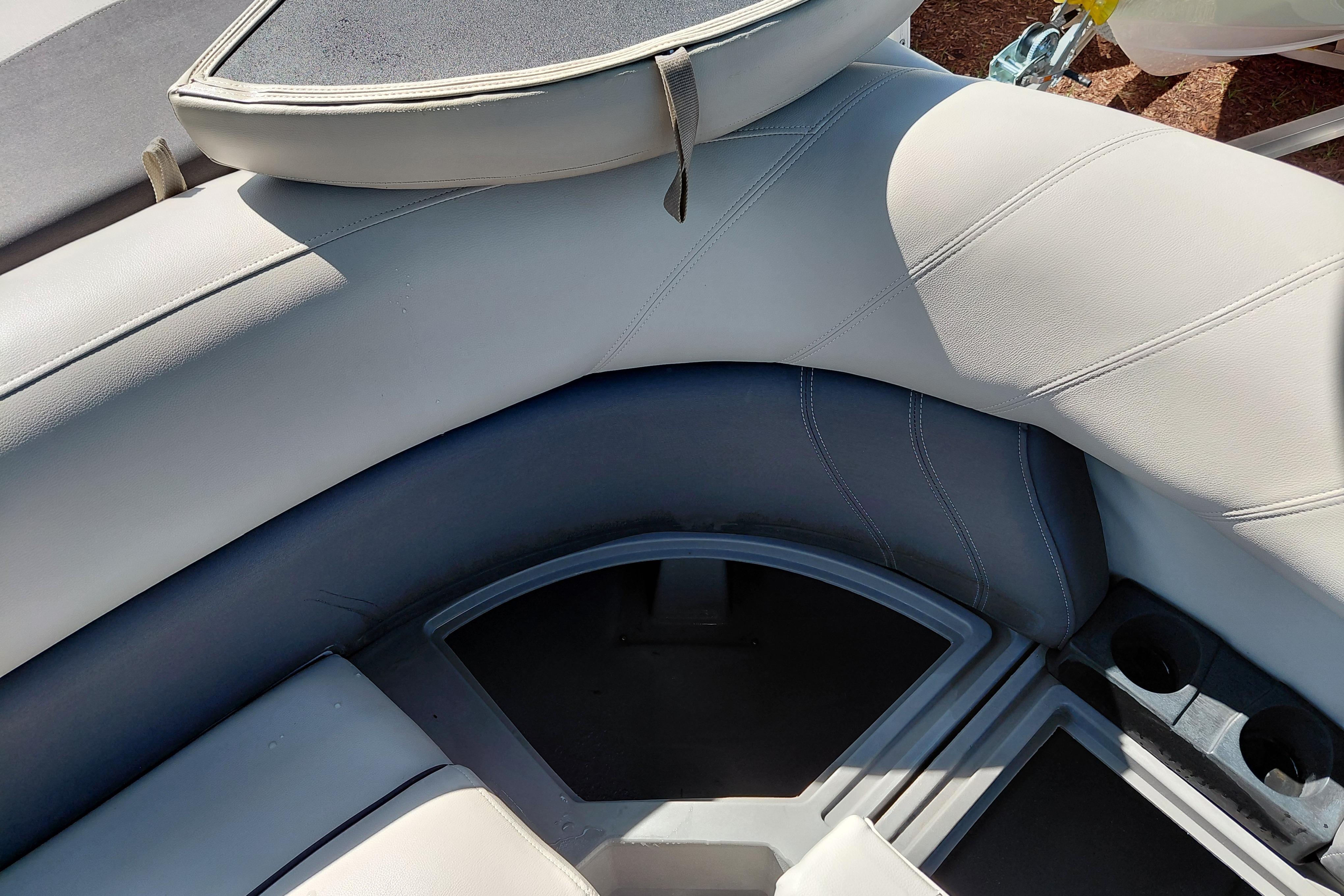 2021 Sylvan Mirage 8520 Cruise boat interior with cushioned seating and cup holders.