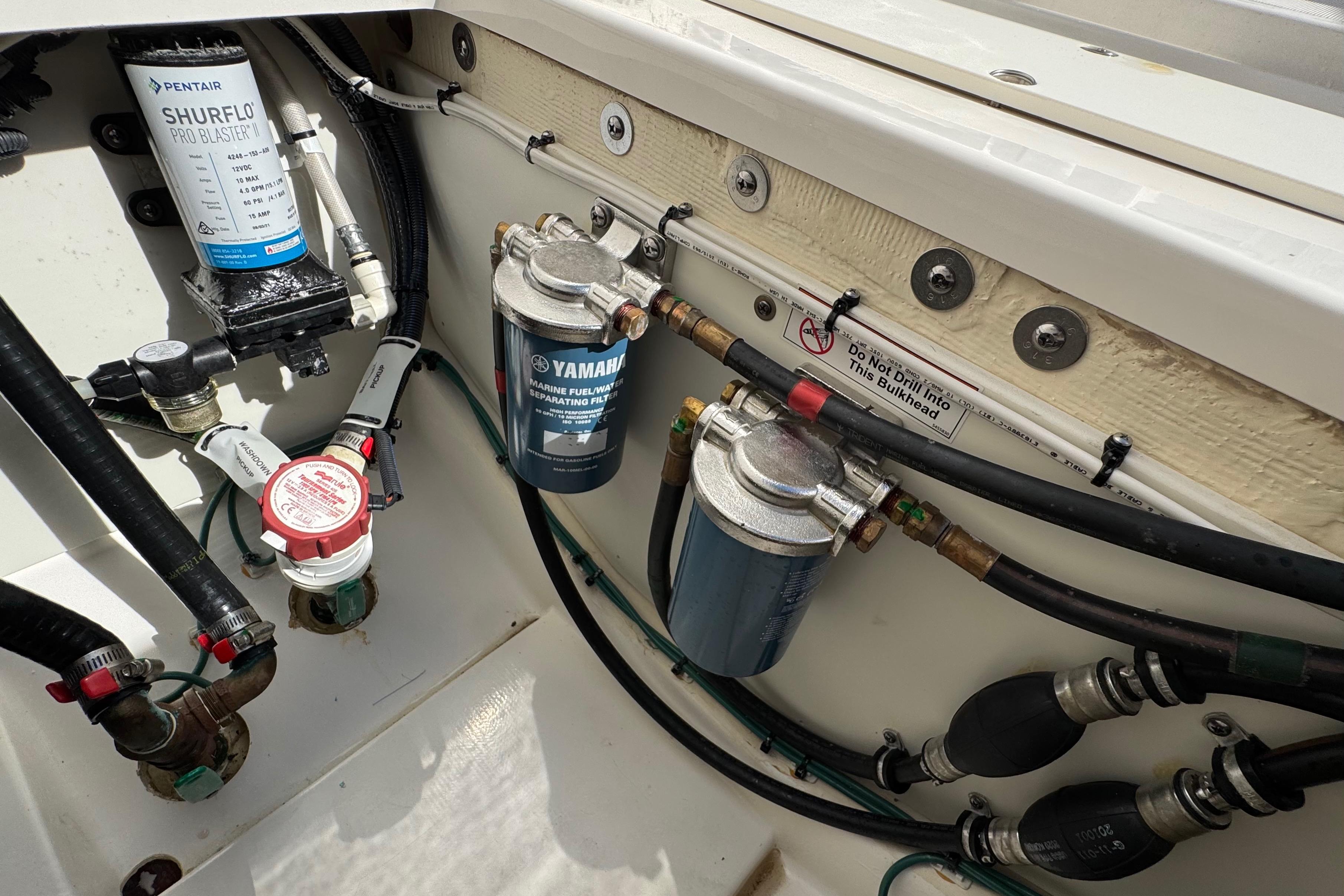 2022 Pursuit DC 266 Dual Console boat engine compartment with fuel and water systems.