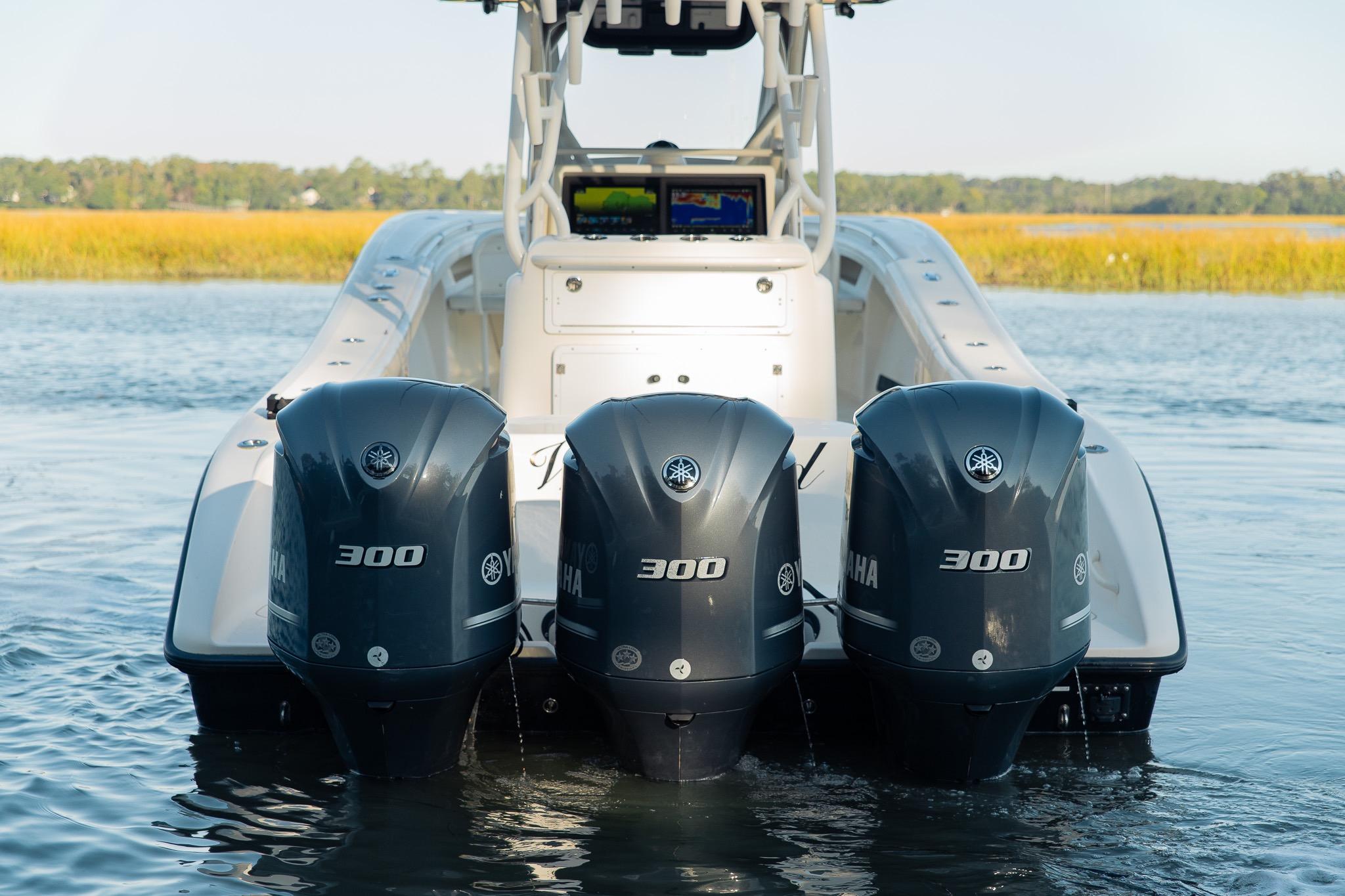 2014 Yellowfin 34 Offshore boat with triple Yamaha 300 engines on water.