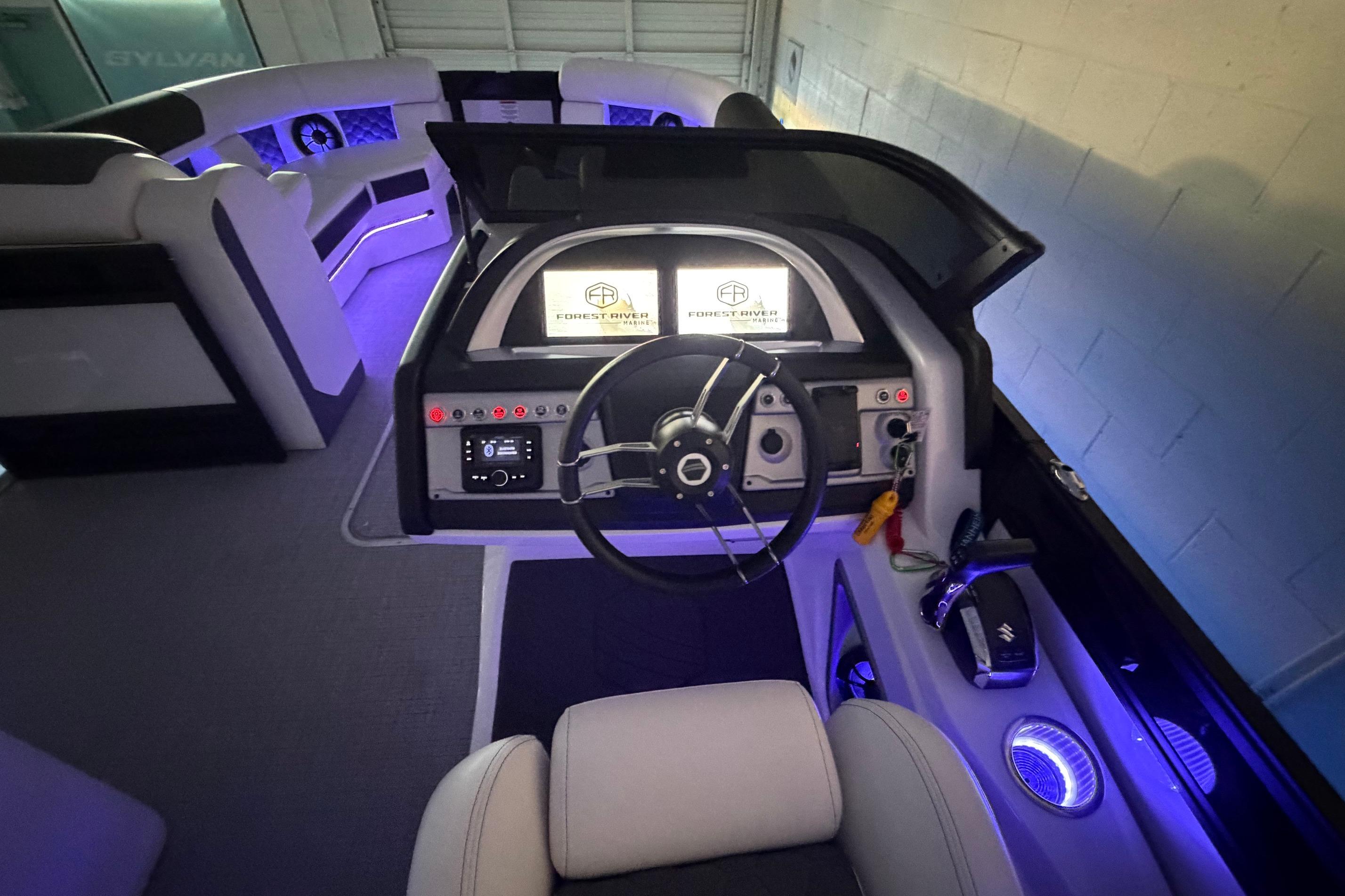 Luxurious interior of 2026 South Bay 525SB2 boat with illuminated dashboard and seating.