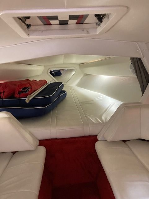 Interior of a 2001 Fountain Lightning boat with white upholstery.