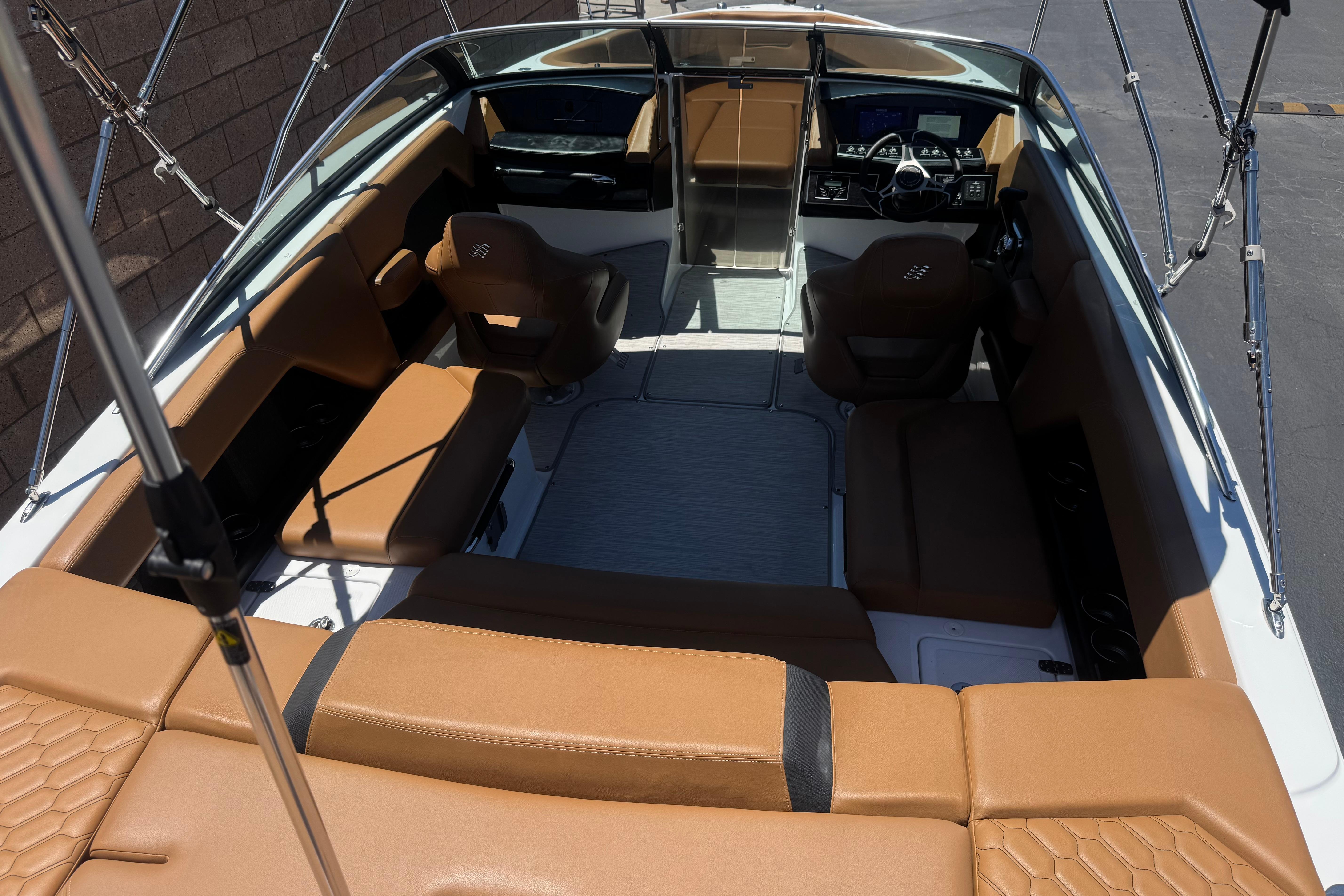 2022 Four Winns H4 boat interior with tan seating and modern dashboard.