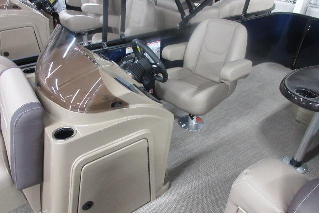 2026 Sylvan Mirage 820 Cruise interior with beige seating and modern helm design.