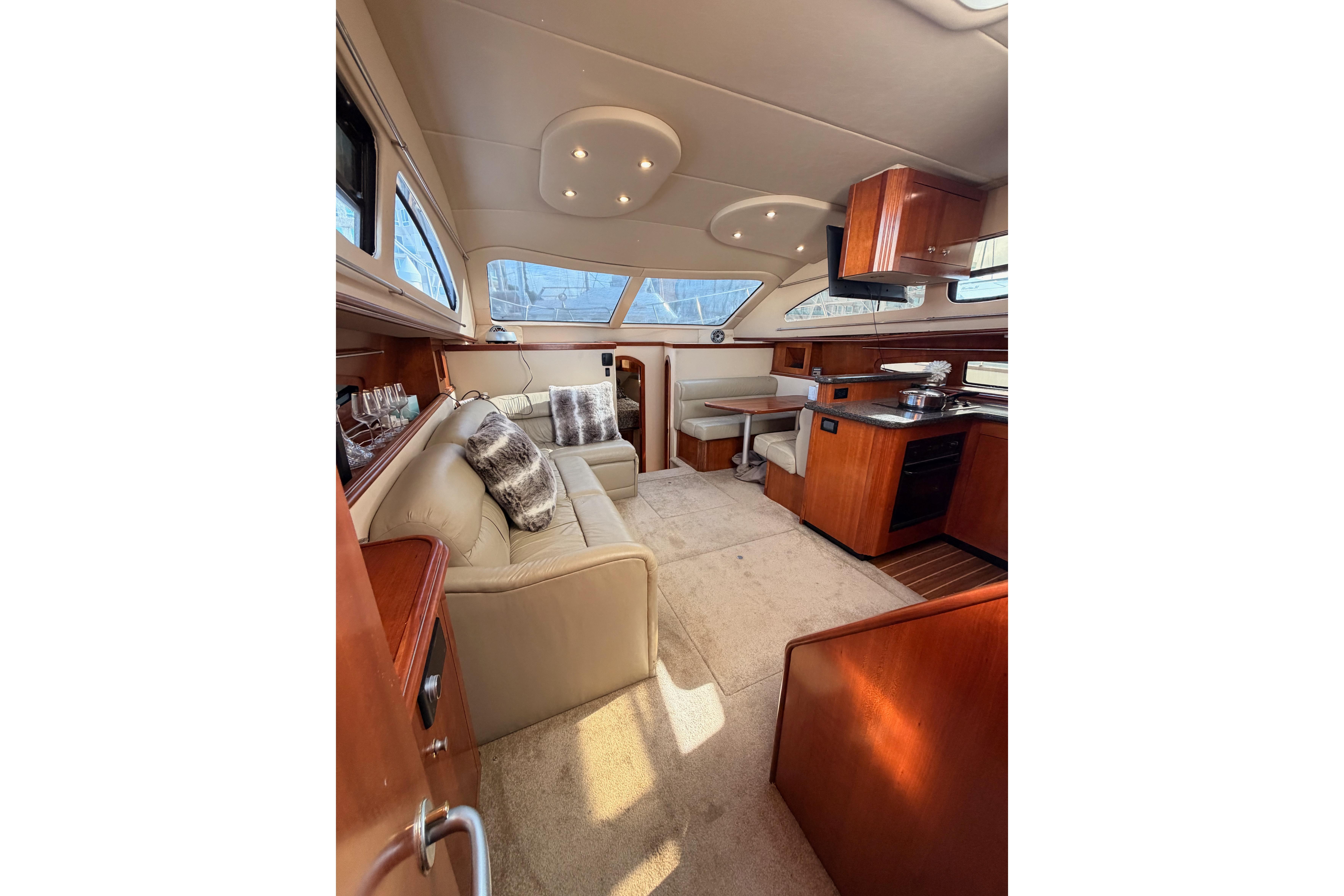 Luxurious interior of 2005 Cruisers Yachts 405 Express Motoryacht with plush seating and elegant wood finishes.