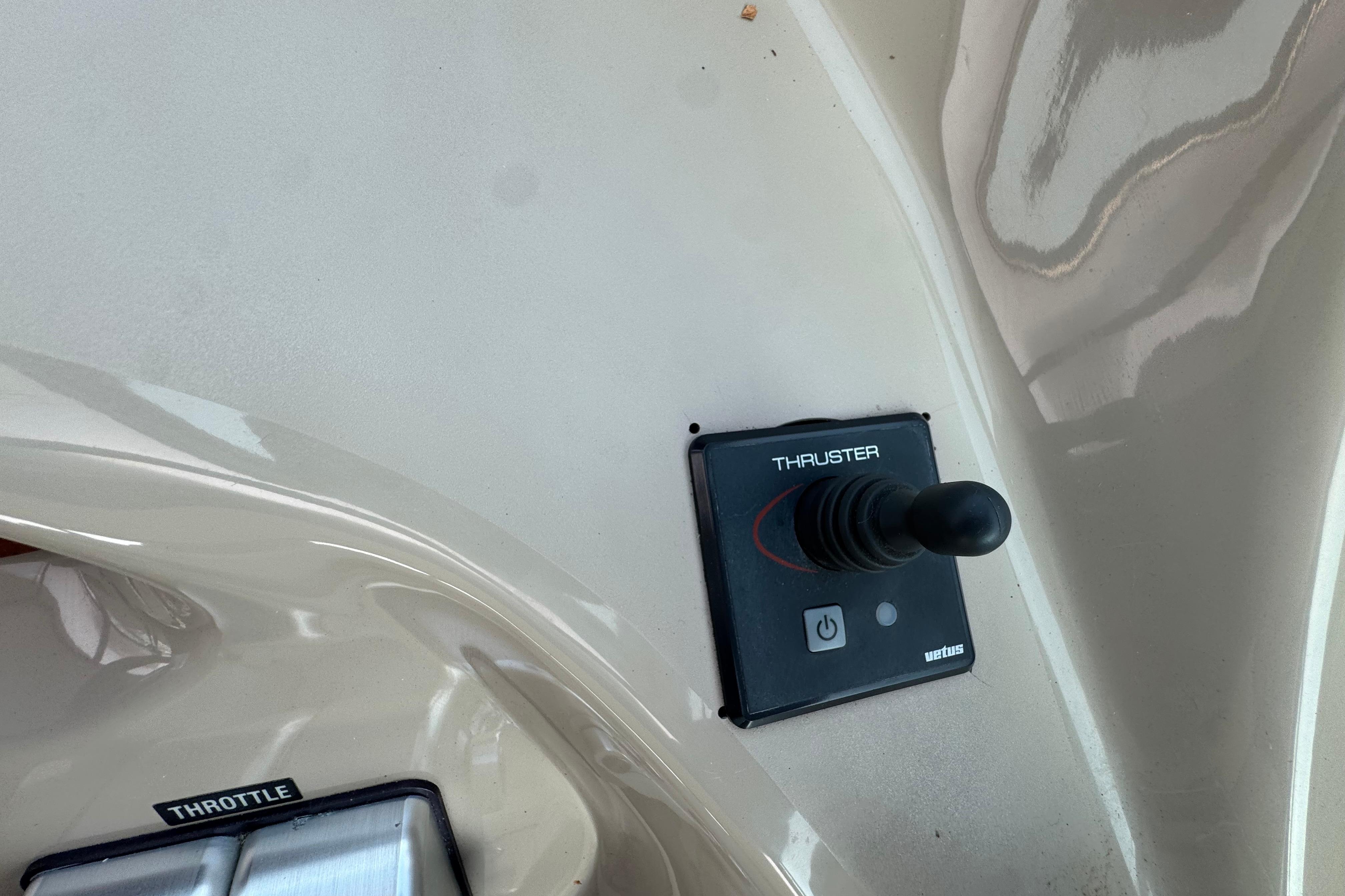 Control panel of a 2001 Sea Ray 510 Sundancer with thruster joystick and throttle.