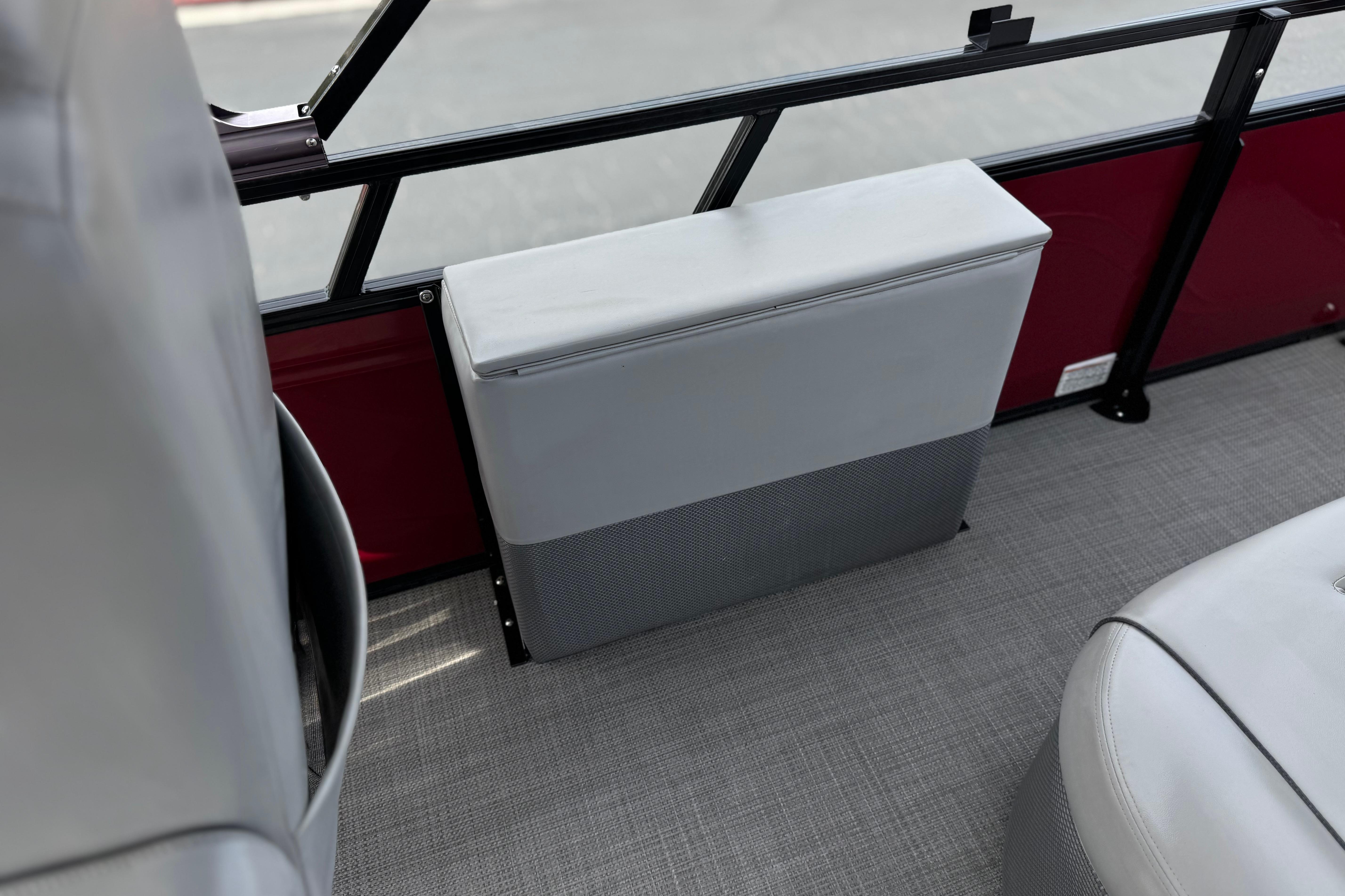 Interior of 2022 Regency 250 DL3 boat with gray seating and red paneling.