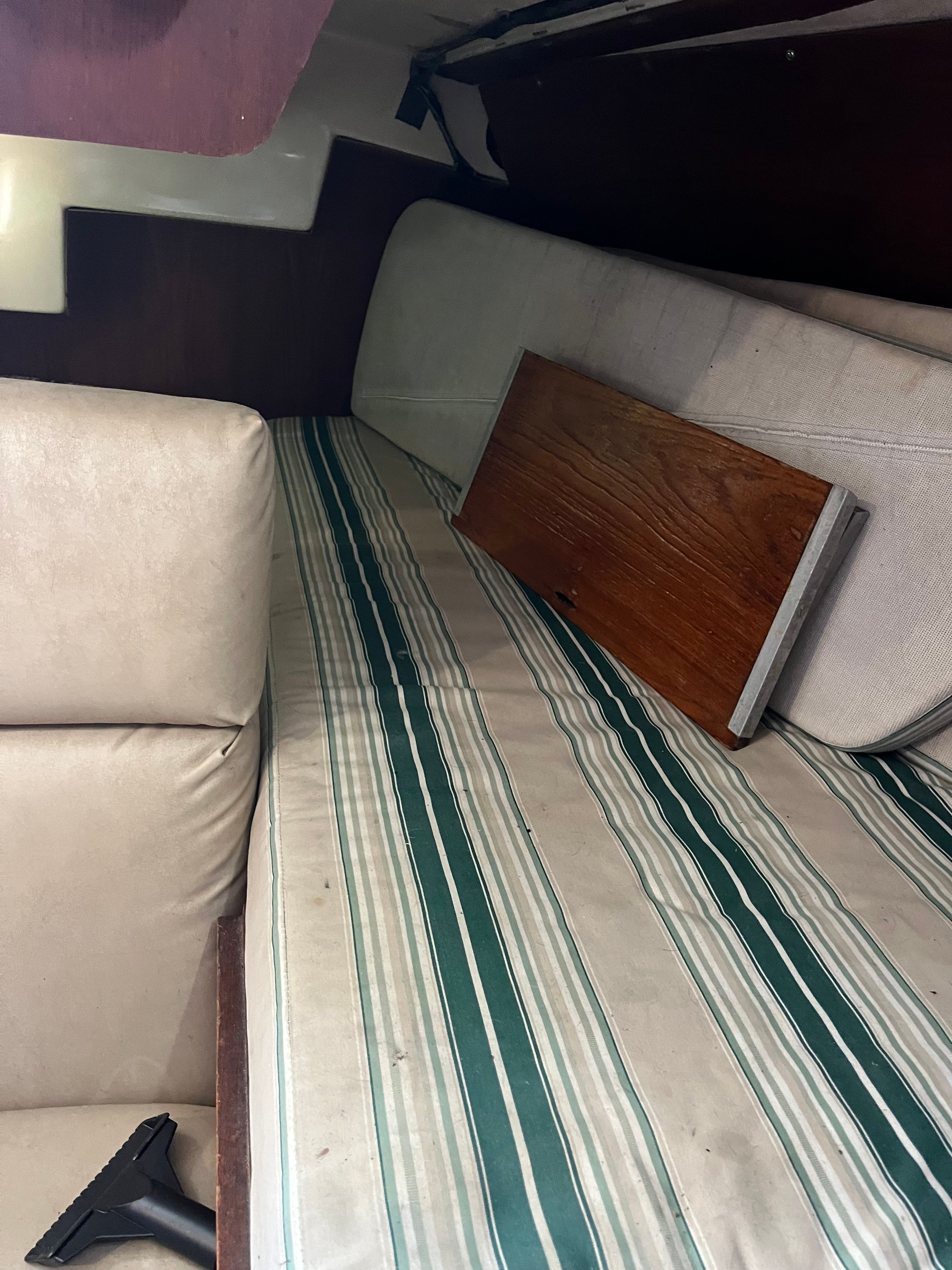 Interior of a 1981 Tartan Sloop with striped upholstery.