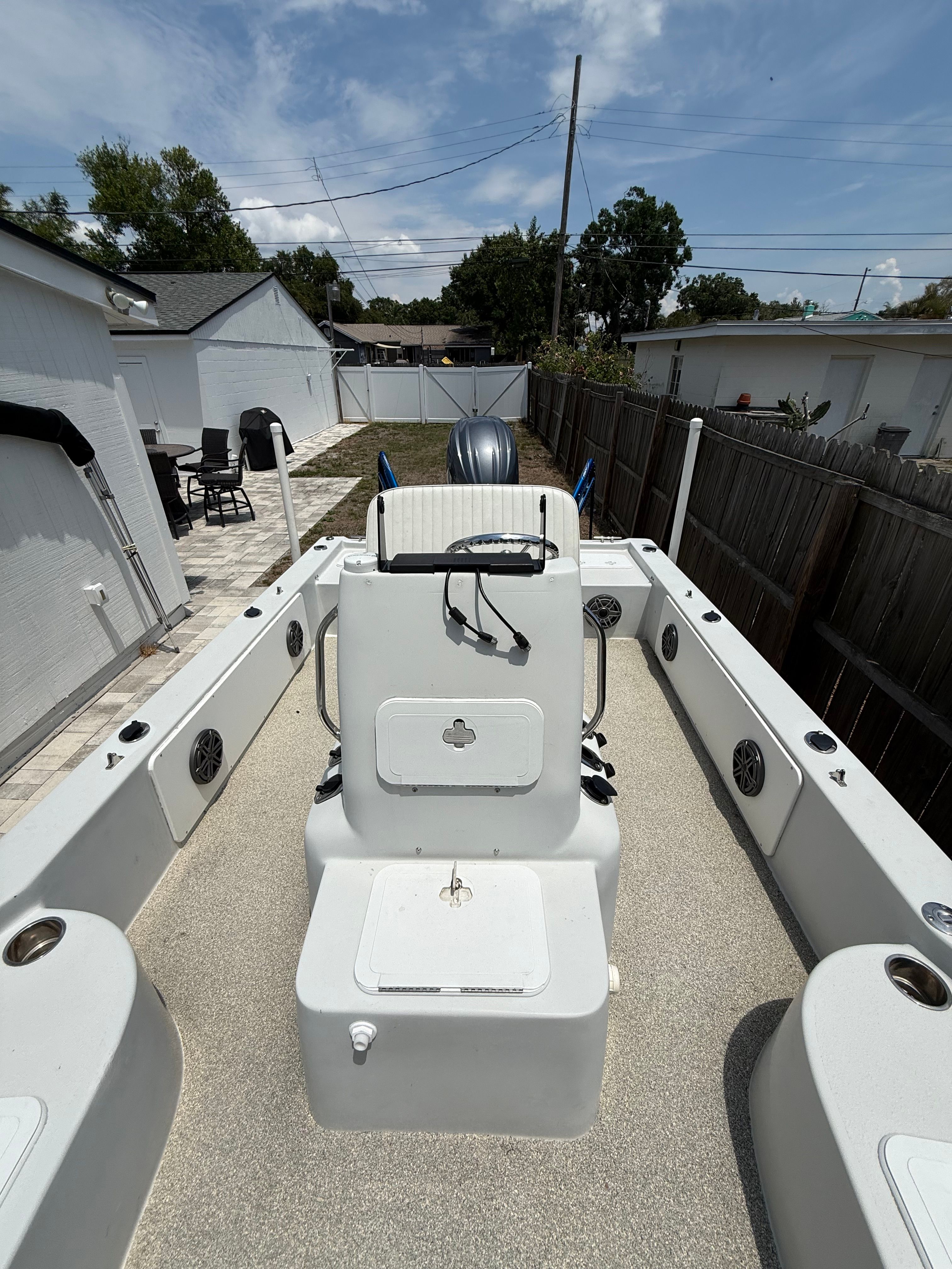 2012 Bay Craft 21 boat parked in backyard.