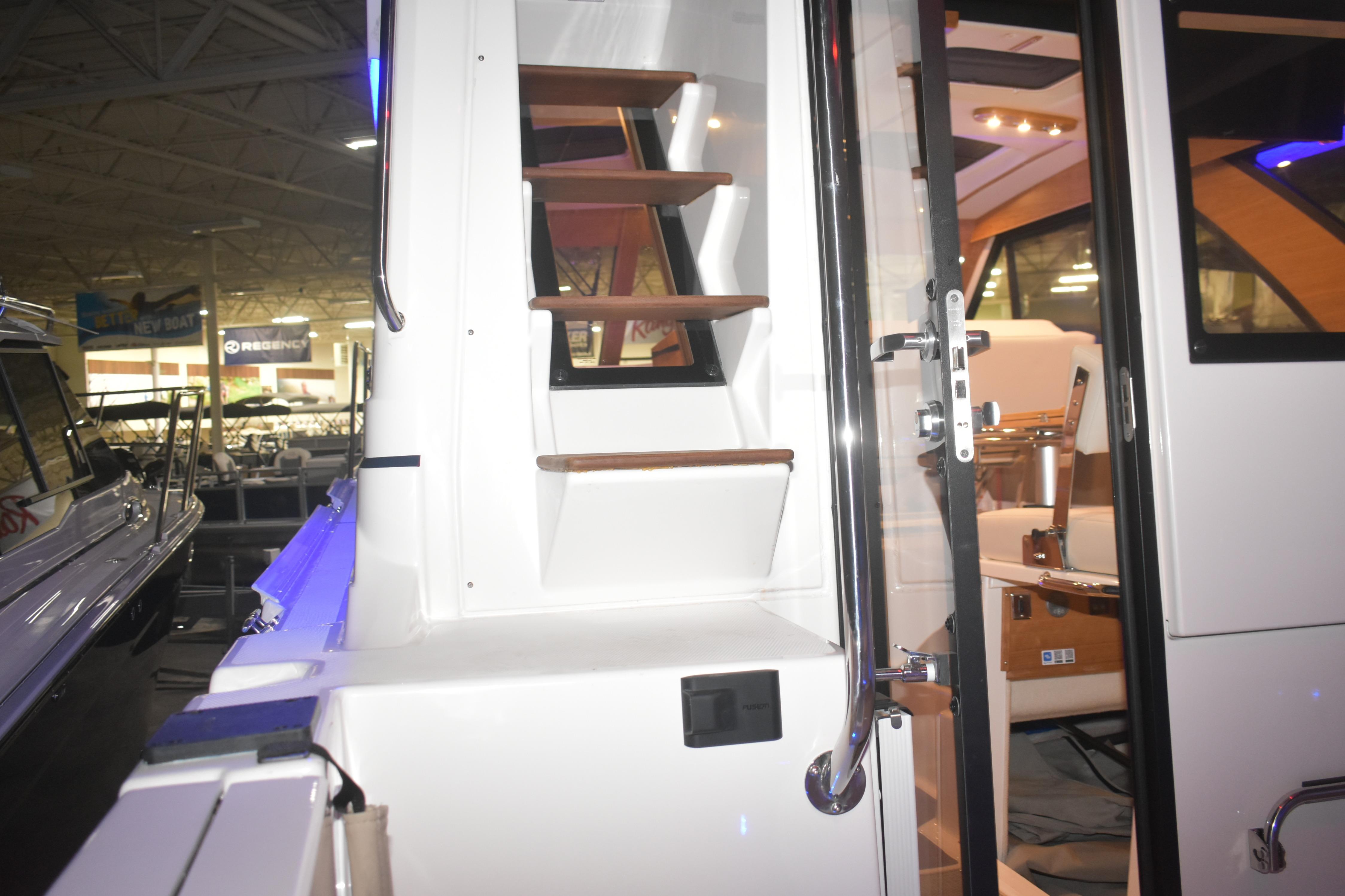 2026 Cutwater C-32 CB boat interior with stairs and seating area.