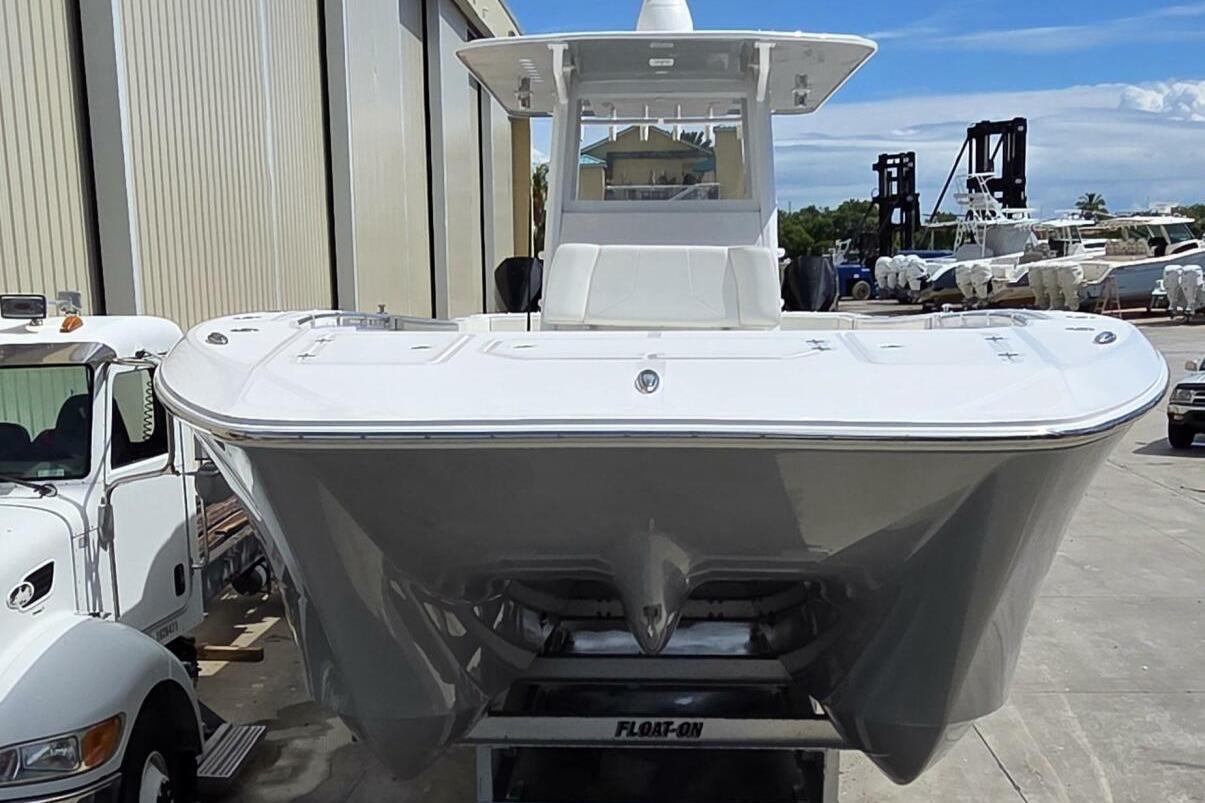 2020 Invincible 35 Catamaran on trailer, parked outdoors near industrial buildings.