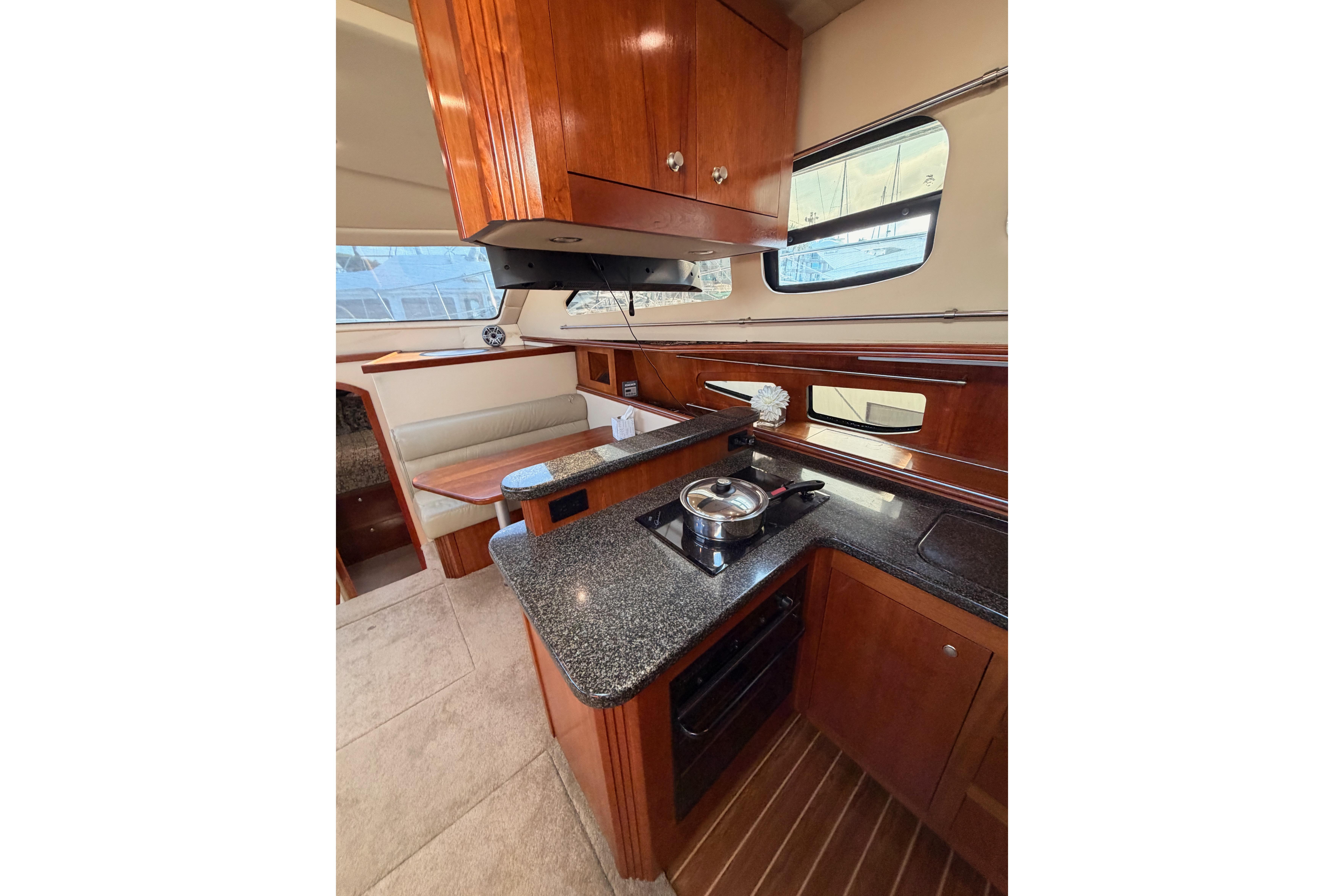 Luxurious 2005 Cruisers Yachts 405 Express Motoryacht interior kitchen with modern amenities.