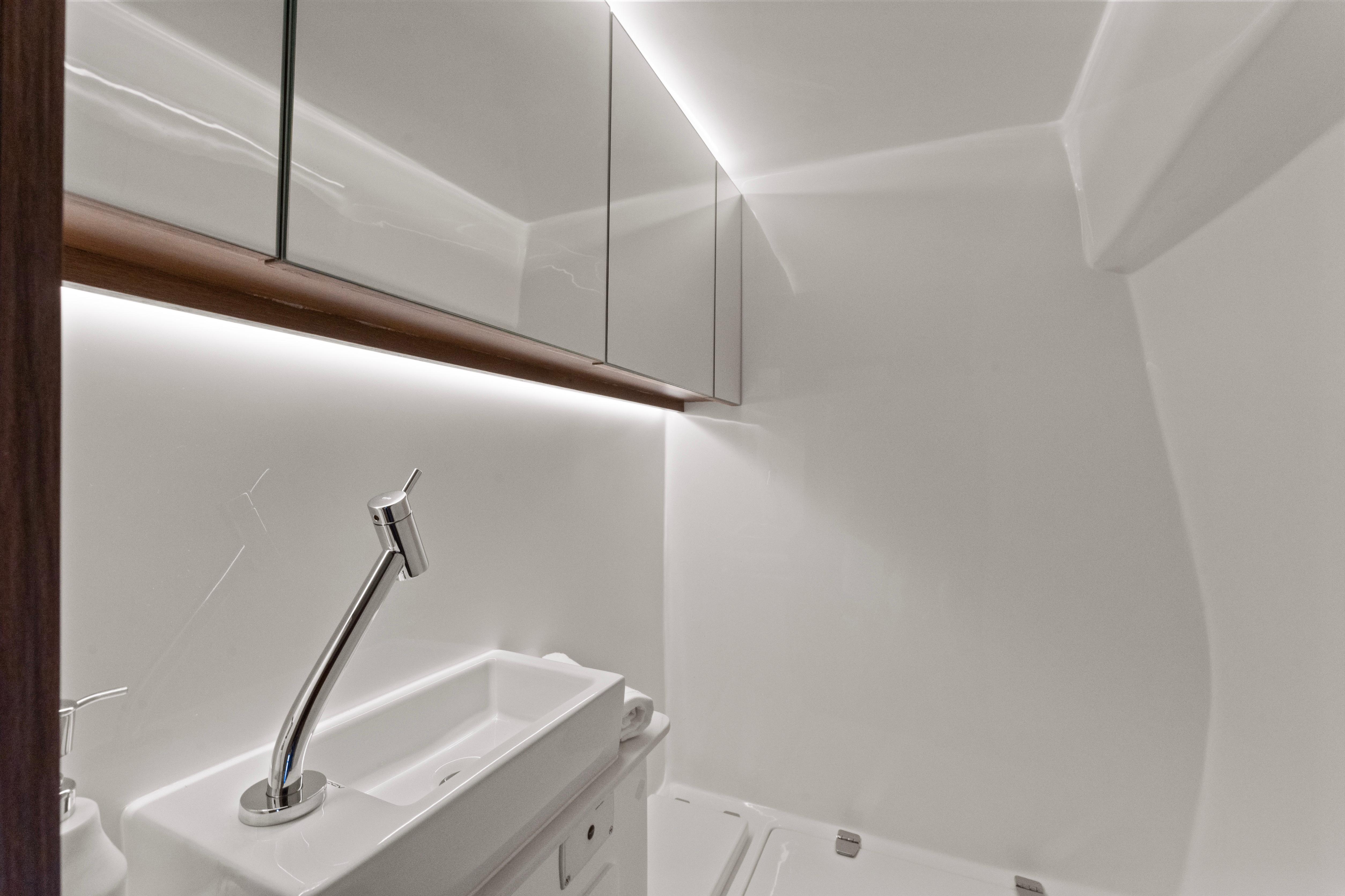 Modern bathroom in 2025 Valiatt 380GT yacht with sleek sink and mirrored cabinets.