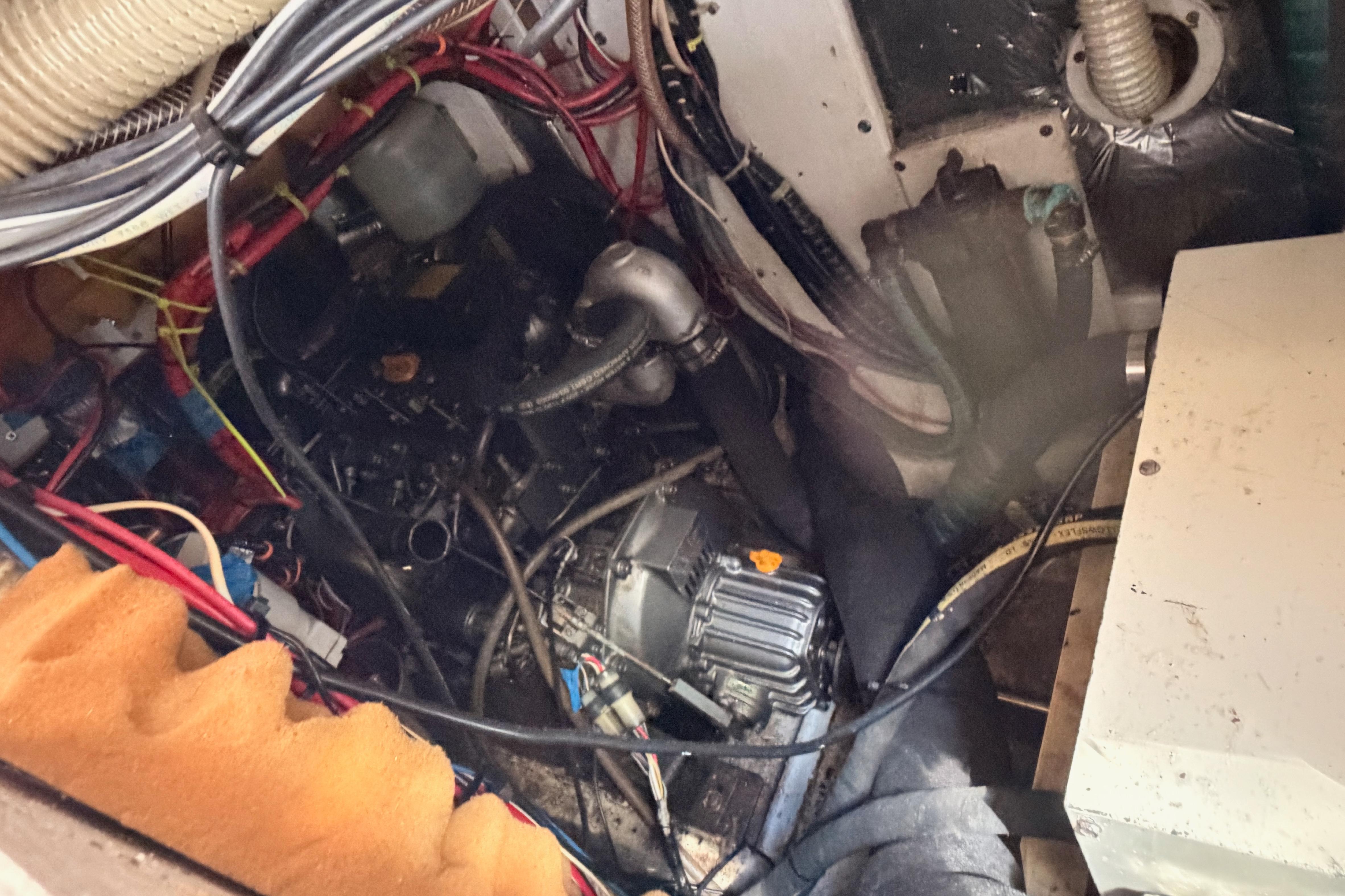 Engine compartment of a 1991 Caliber 33 sailboat, showing wiring and mechanical components.