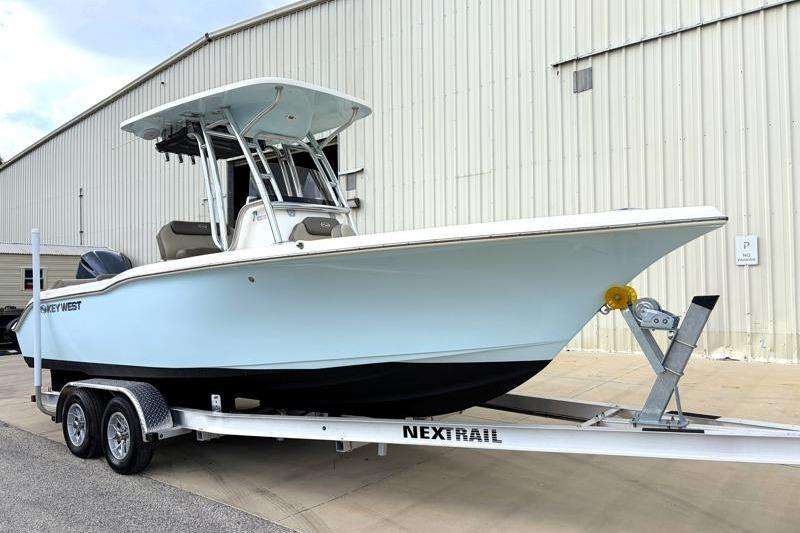 2024 Key West 239 FS boat on trailer, parked outside a large building.