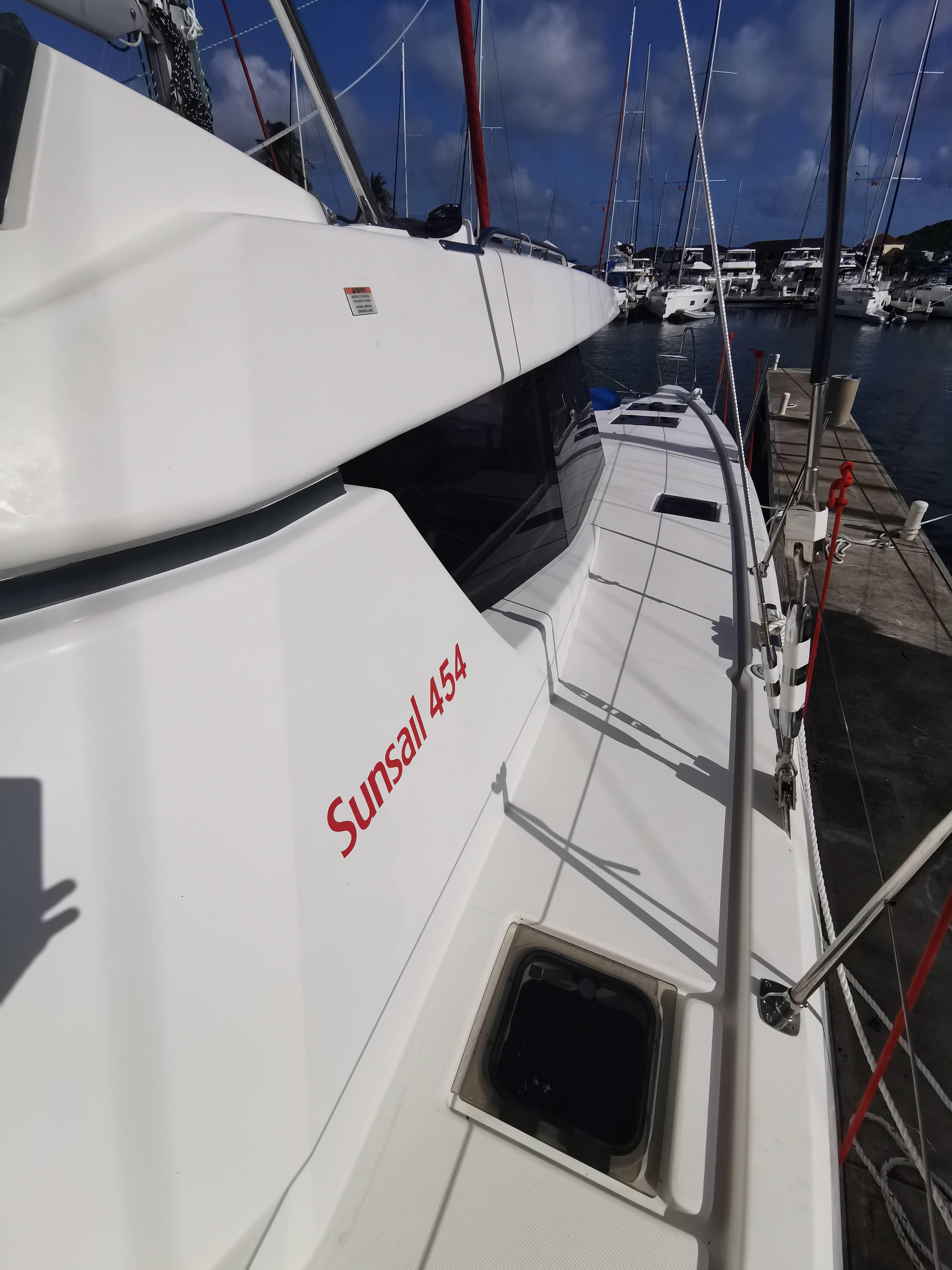 Sailing yacht Leopard 45, 2022 model, docked at marina under clear blue sky.