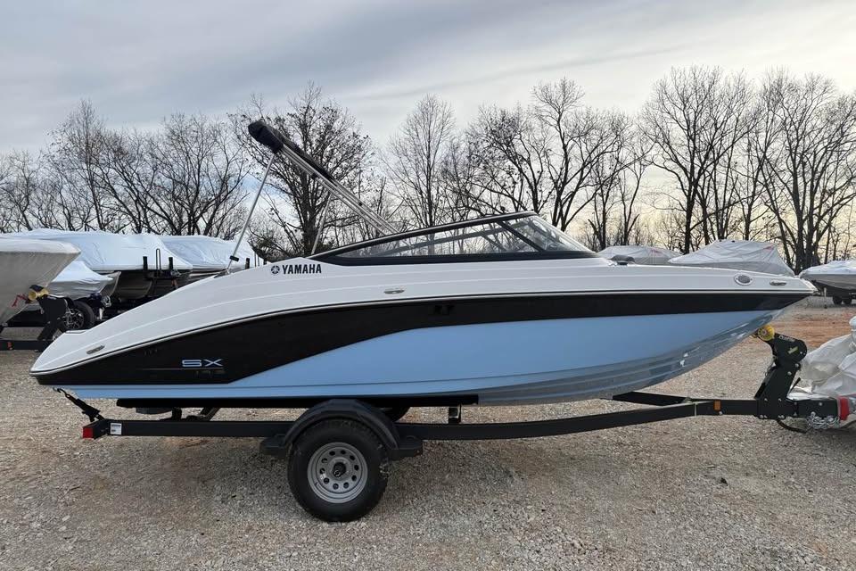 2026 Yamaha Boats SX195 on trailer, parked outdoors with trees in background.