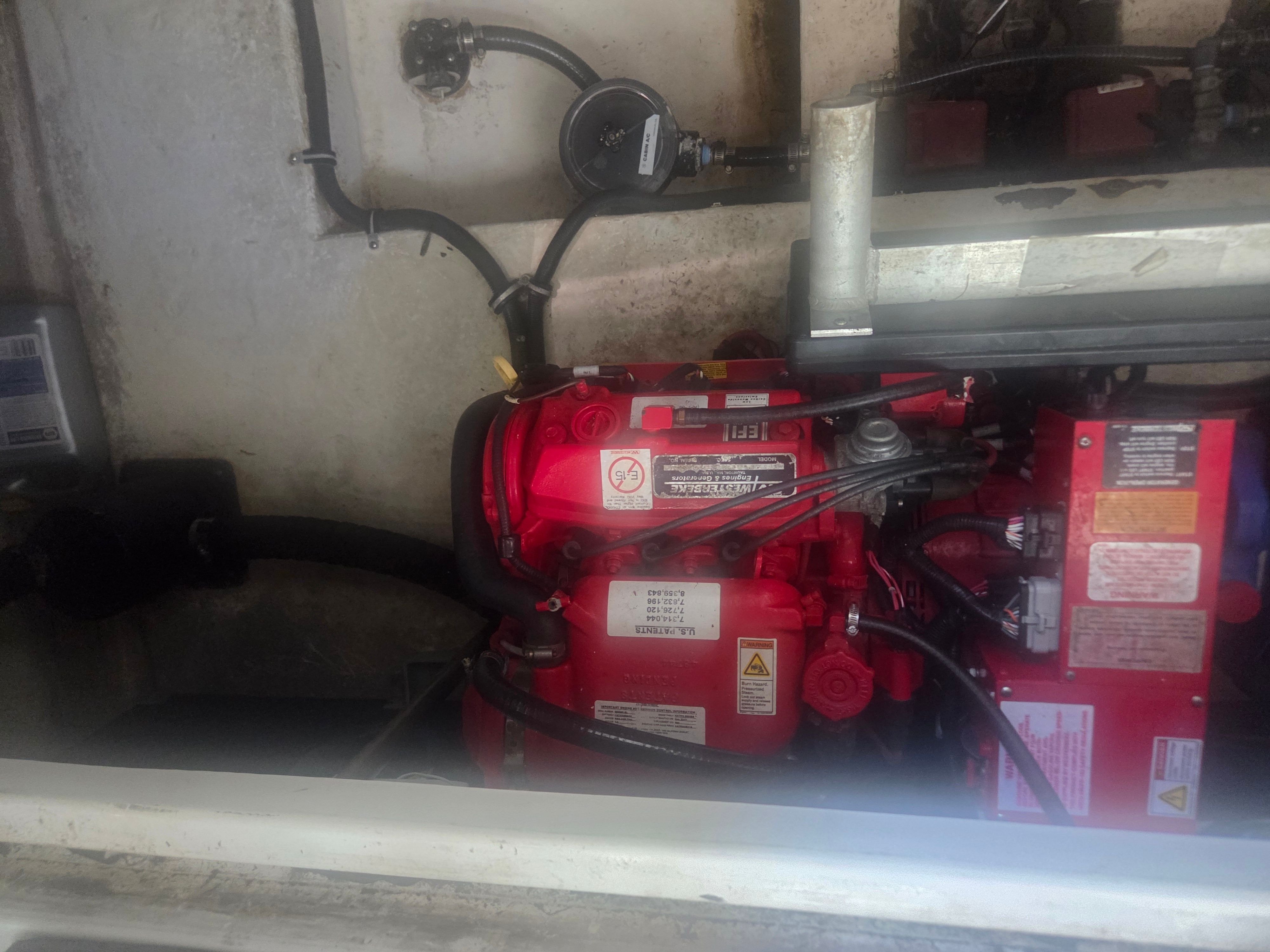 Engine compartment of a 2019 Monterey 360SC boat with red engine.