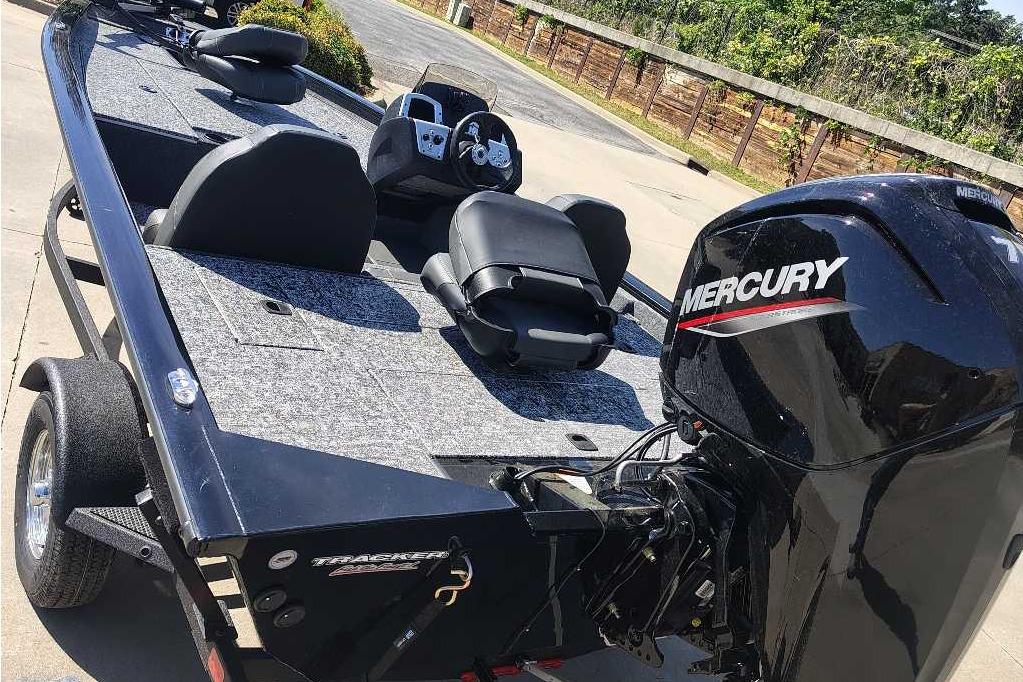 2026 Tracker Pro Team 175 boat with Mercury engine, parked on a driveway.