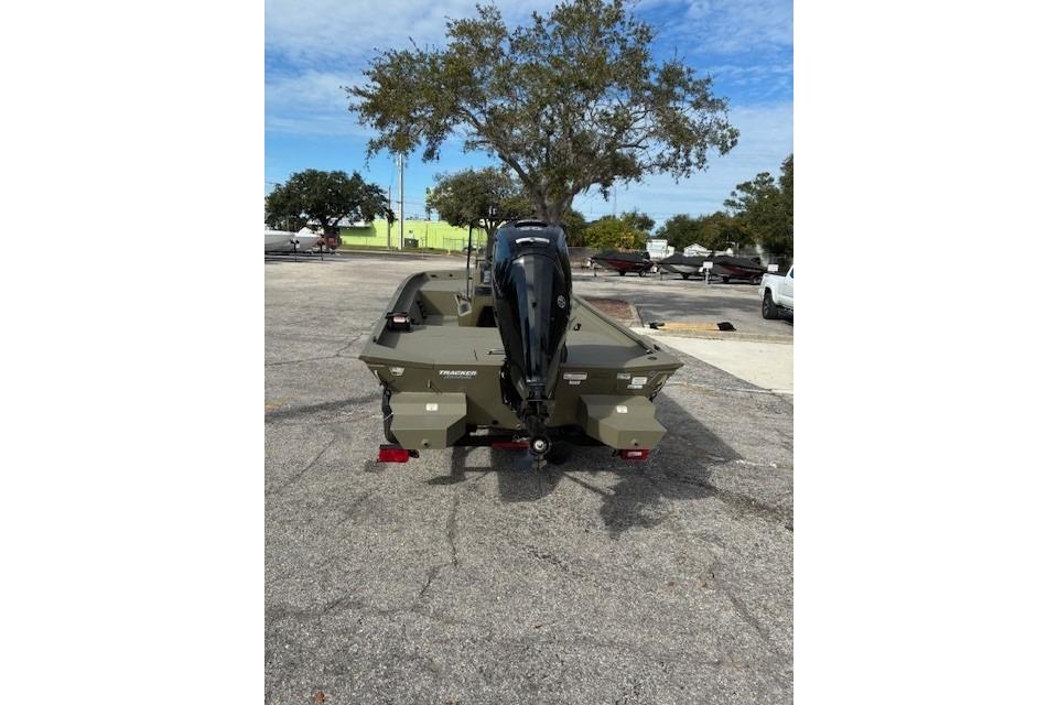 2026 Tracker Grizzly 1860 CC boat with outboard motor in a parking lot.