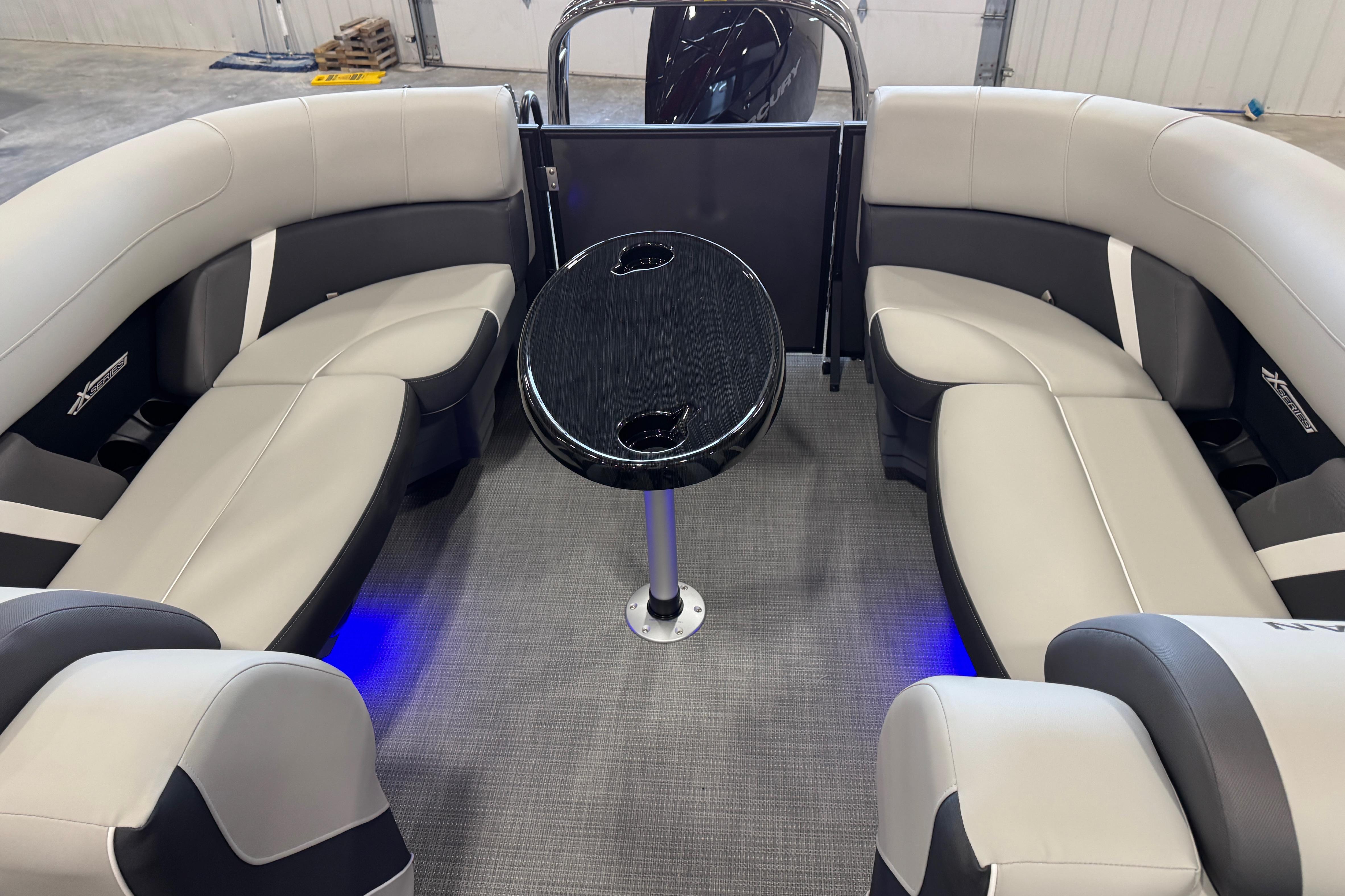 Luxurious interior of 2026 Sylvan Mirage X X5 pontoon boat with elegant seating and table.