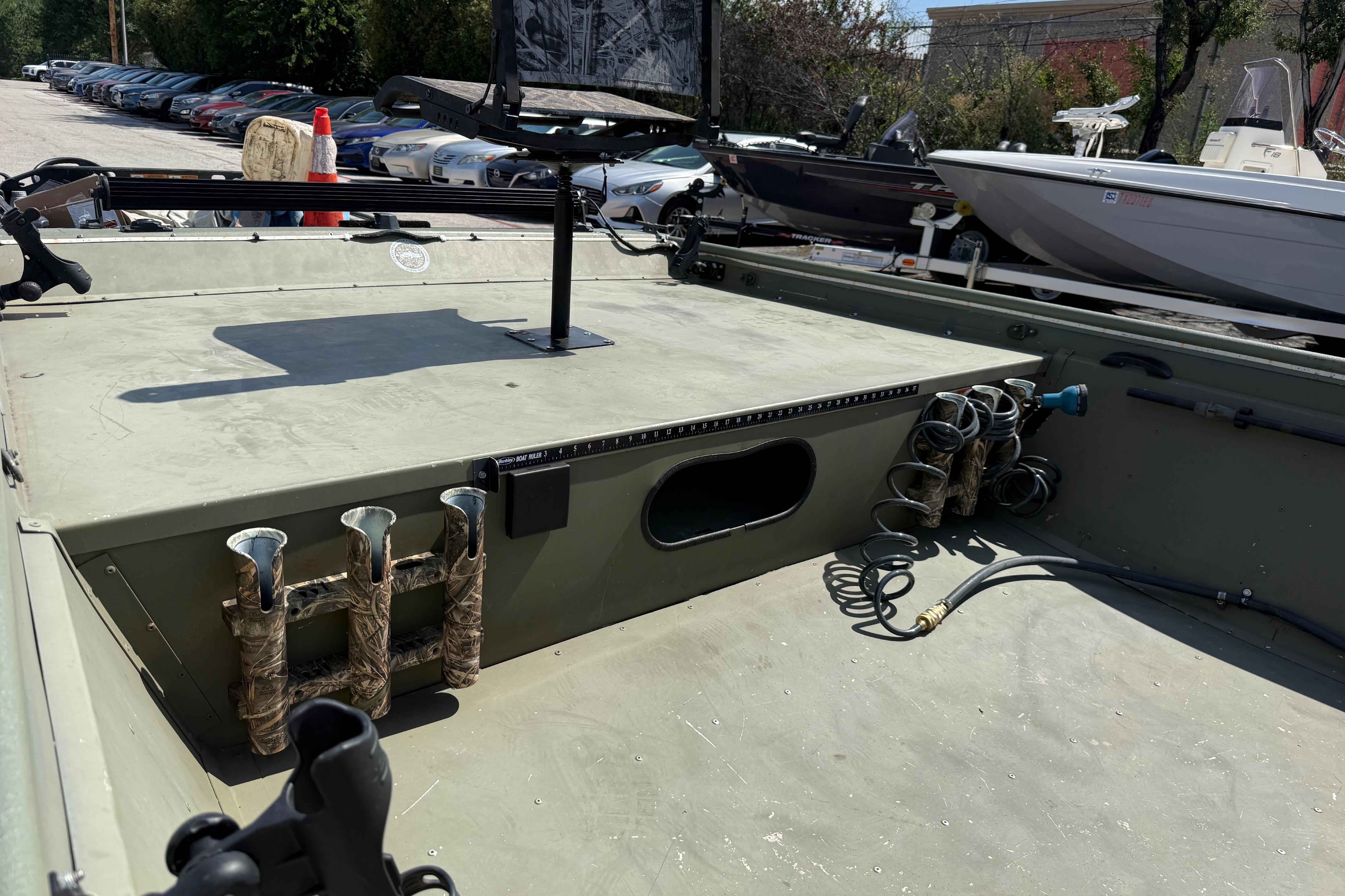 The image shows the deck of a 2020 Lowe Roughneck 2070 Big River boat with fishing rod holders.