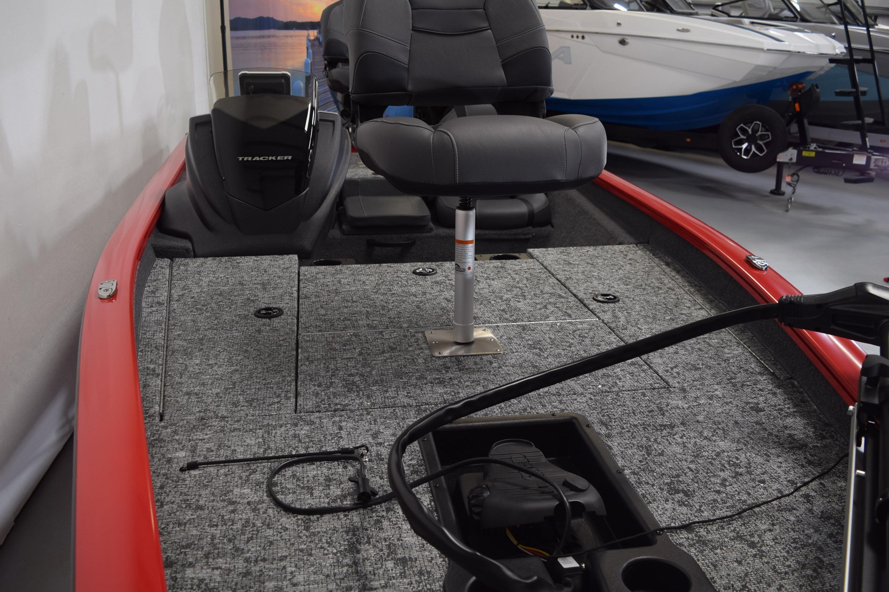 2026 Tracker Pro Team 175 boat interior with gray seating and red trim.