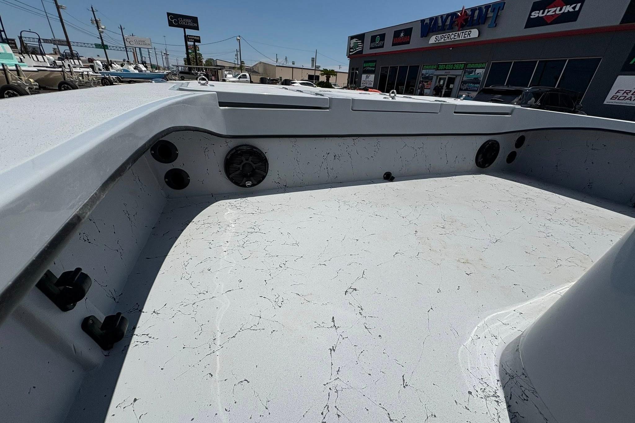 2026 Freedom Boats 23' Warrior interior with speakers, parked at dealership.