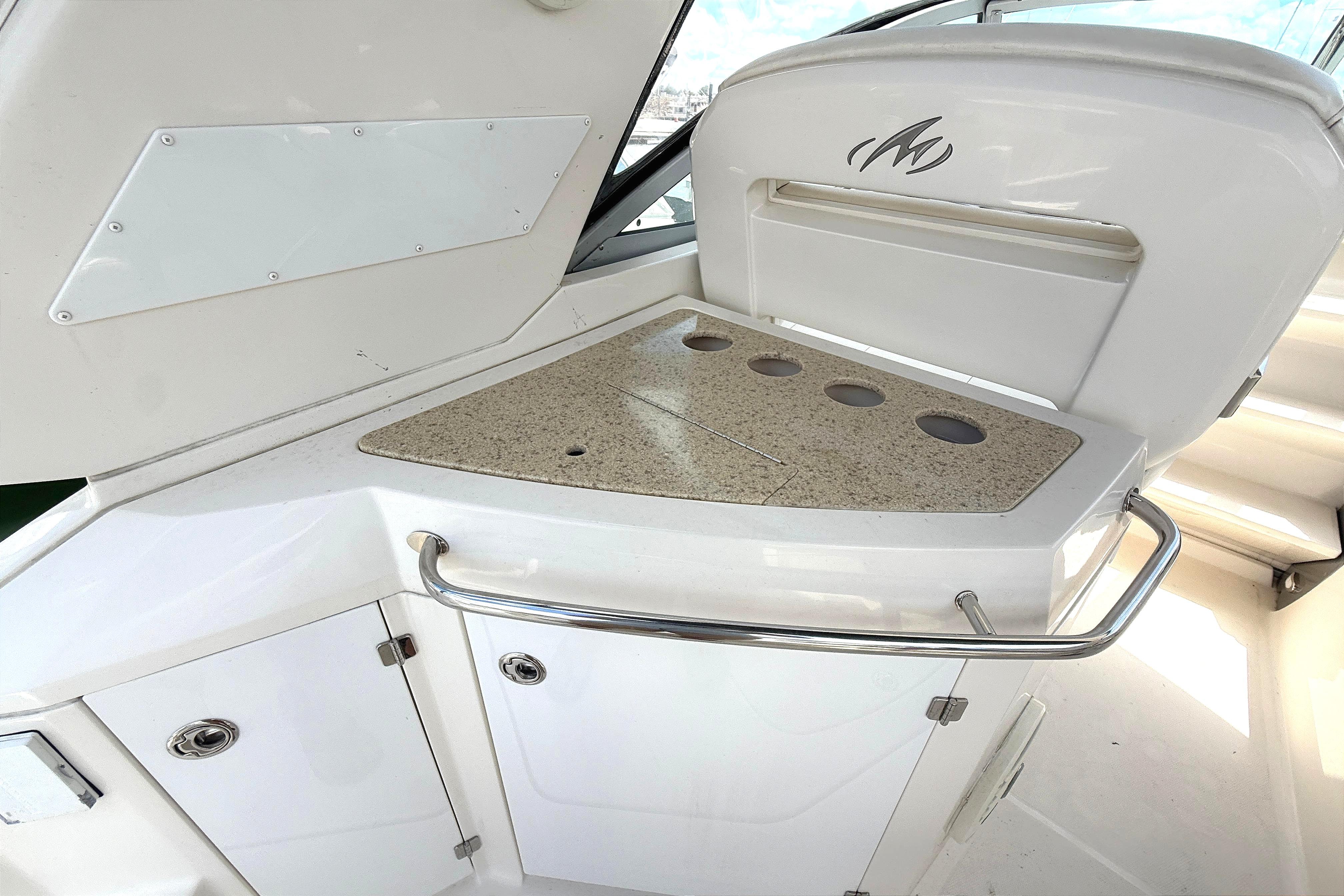2011 Monterey 320 Sport Yacht interior with sleek countertop and storage cabinets.
