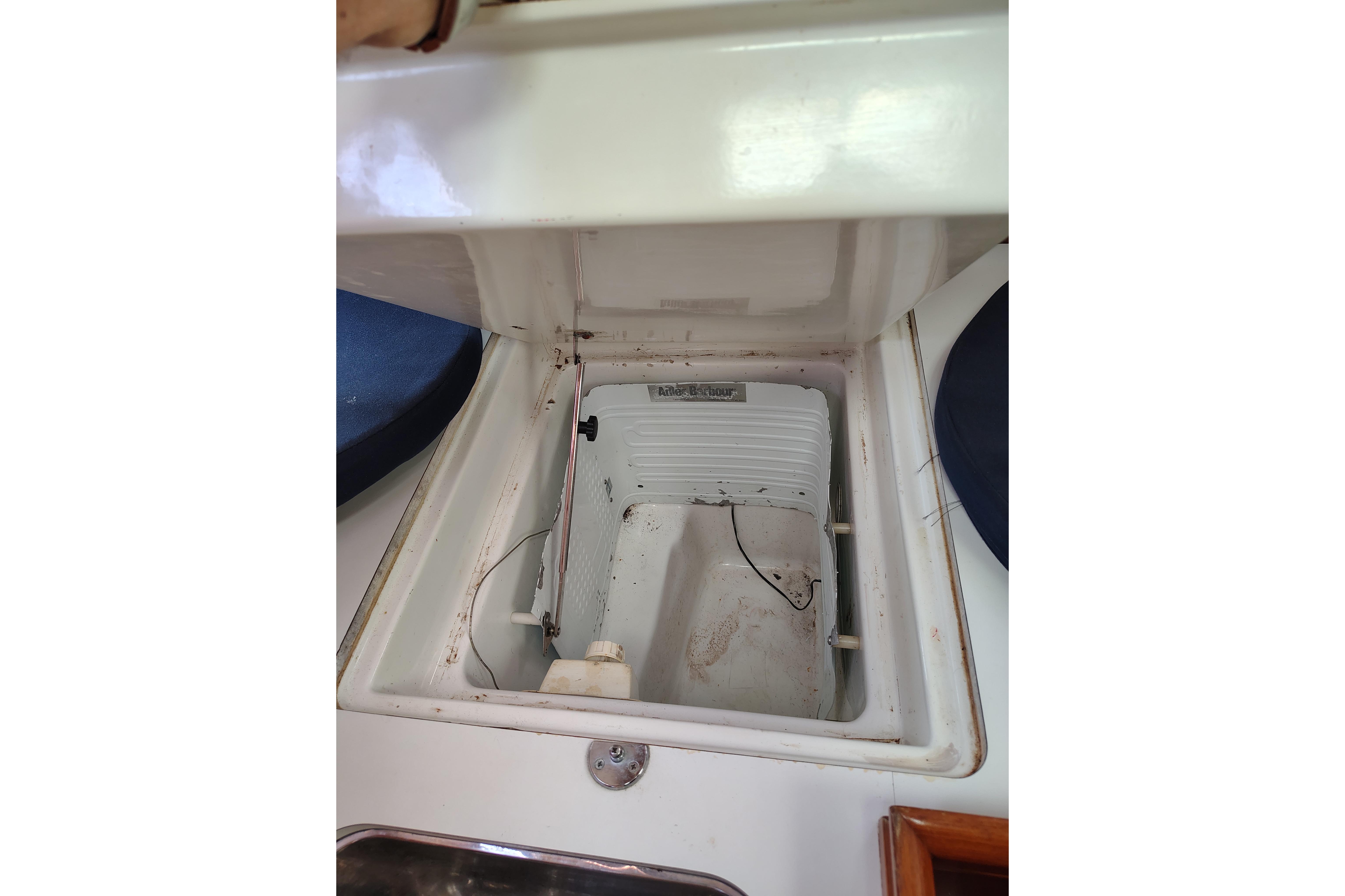 Open storage compartment on a 2001 Beneteau Oceanis 411 sailboat deck.