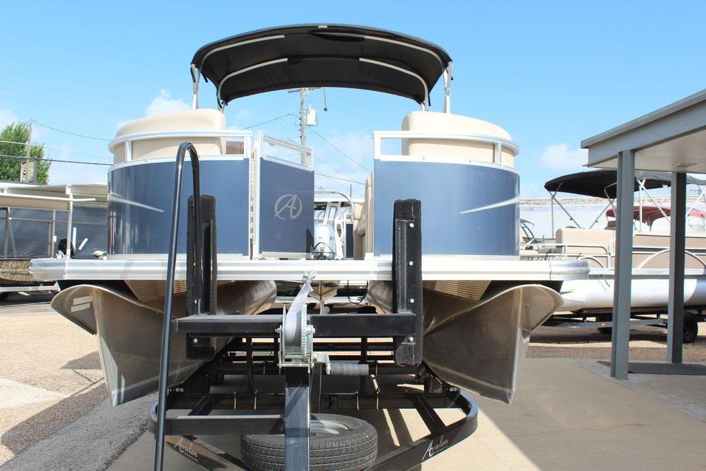 2021 Avalon VLS Quad Lounge 22 FT pontoon boat on trailer, front view.