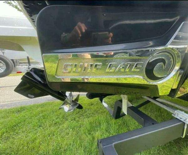2022 Chaparral 23 Surf boat with "Surf Gate" feature on a trailer.