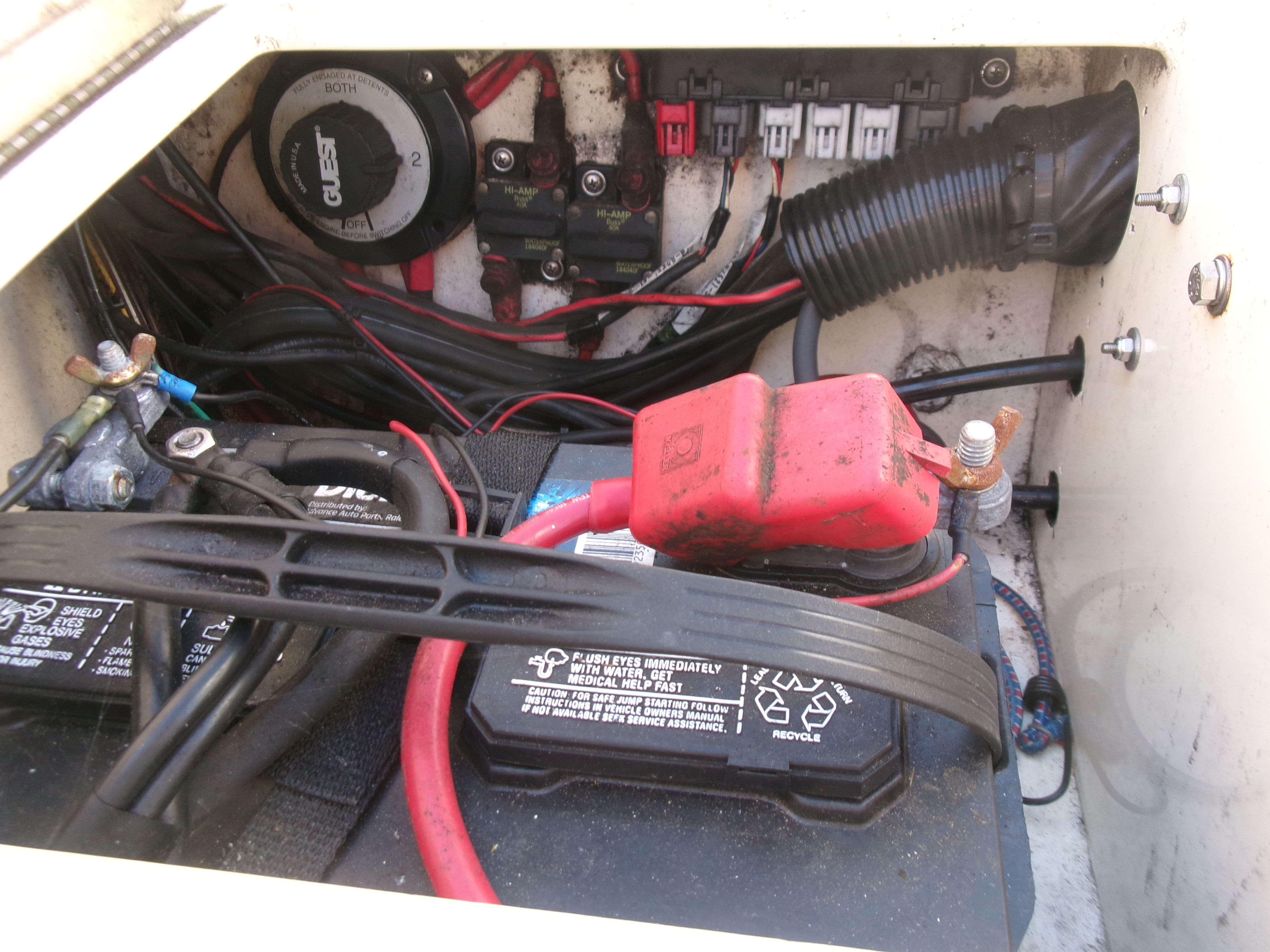 Battery compartment with cables and fuses in a 2007 Parker 2520 XL Sport Cabin boat.